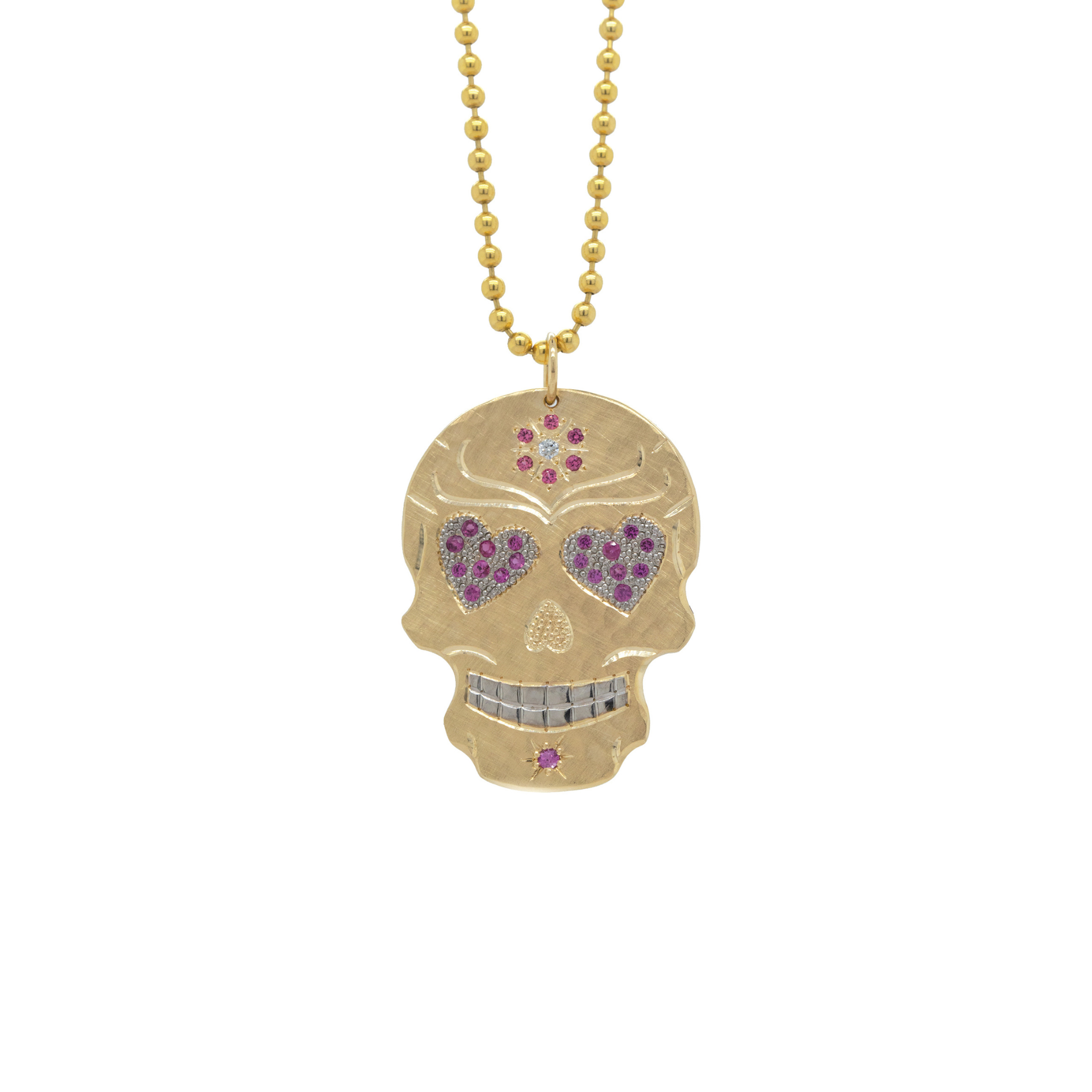 Gold skull pendant necklace with pink heart-shaped stones on a white background by Julez Bryant