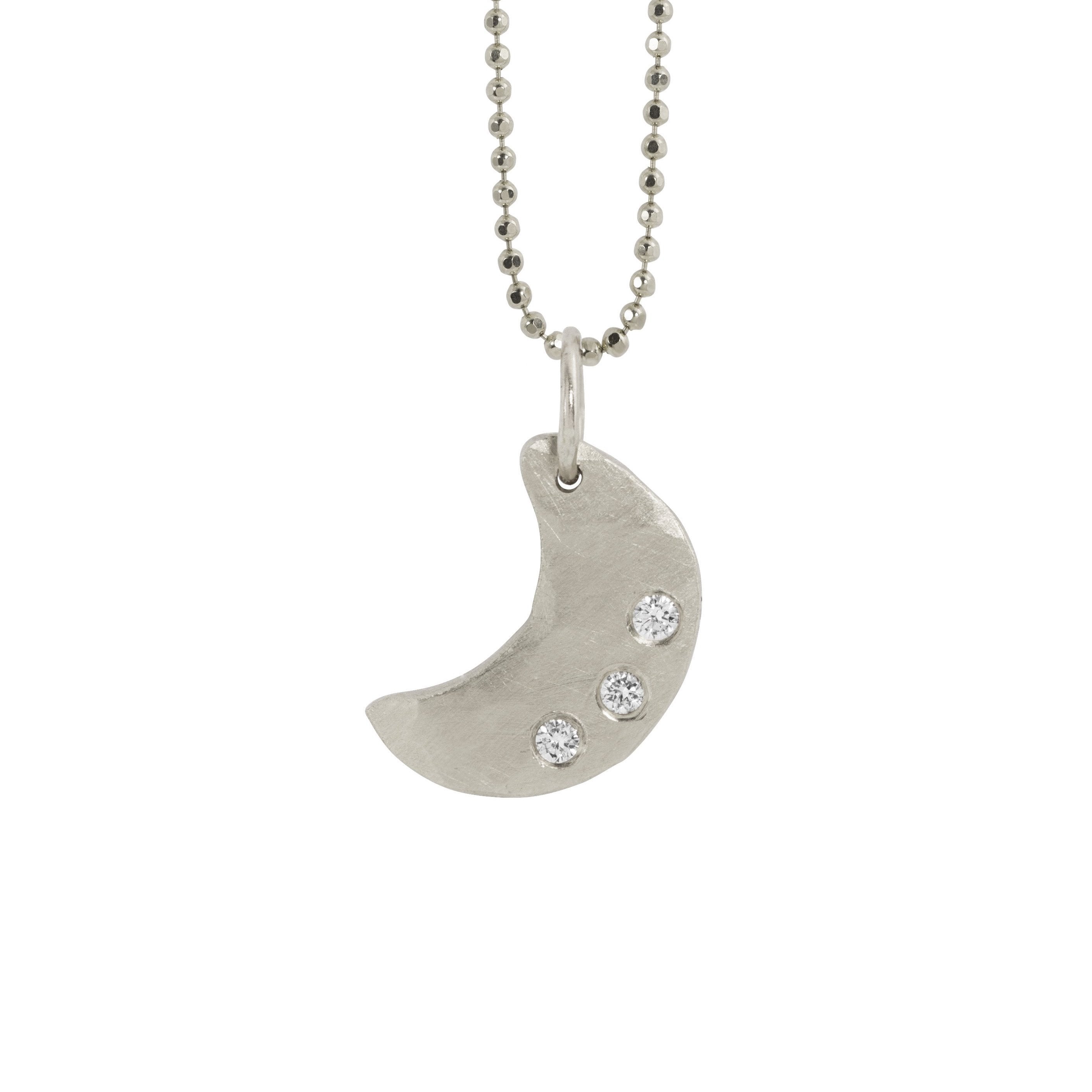 14k white gold necklace with a hammered crescent moon pendant featuring three small white diamonds hanging from diamond cut ball chain on a white background