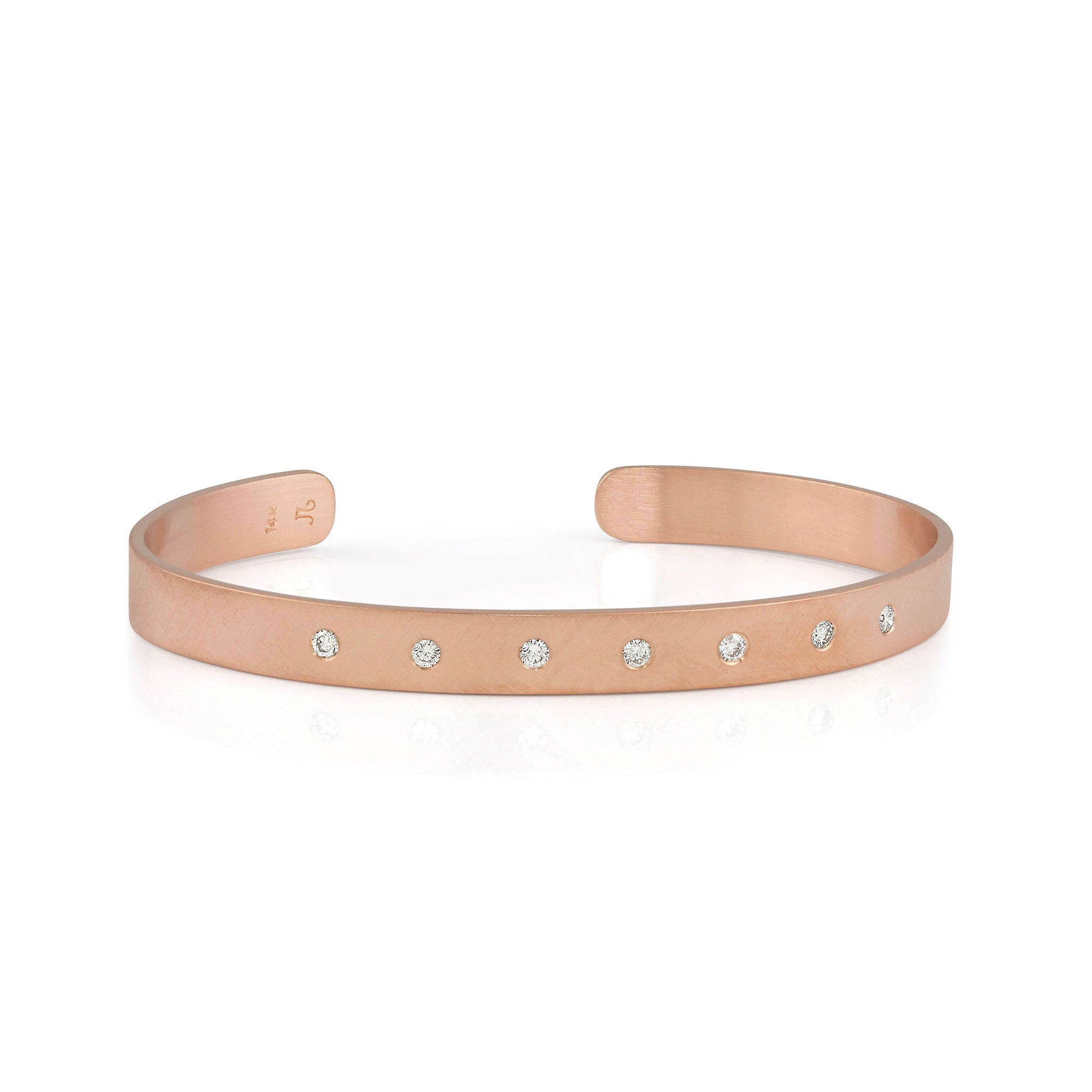14k rose gold satin cuff bracelet with white diamonds on white background