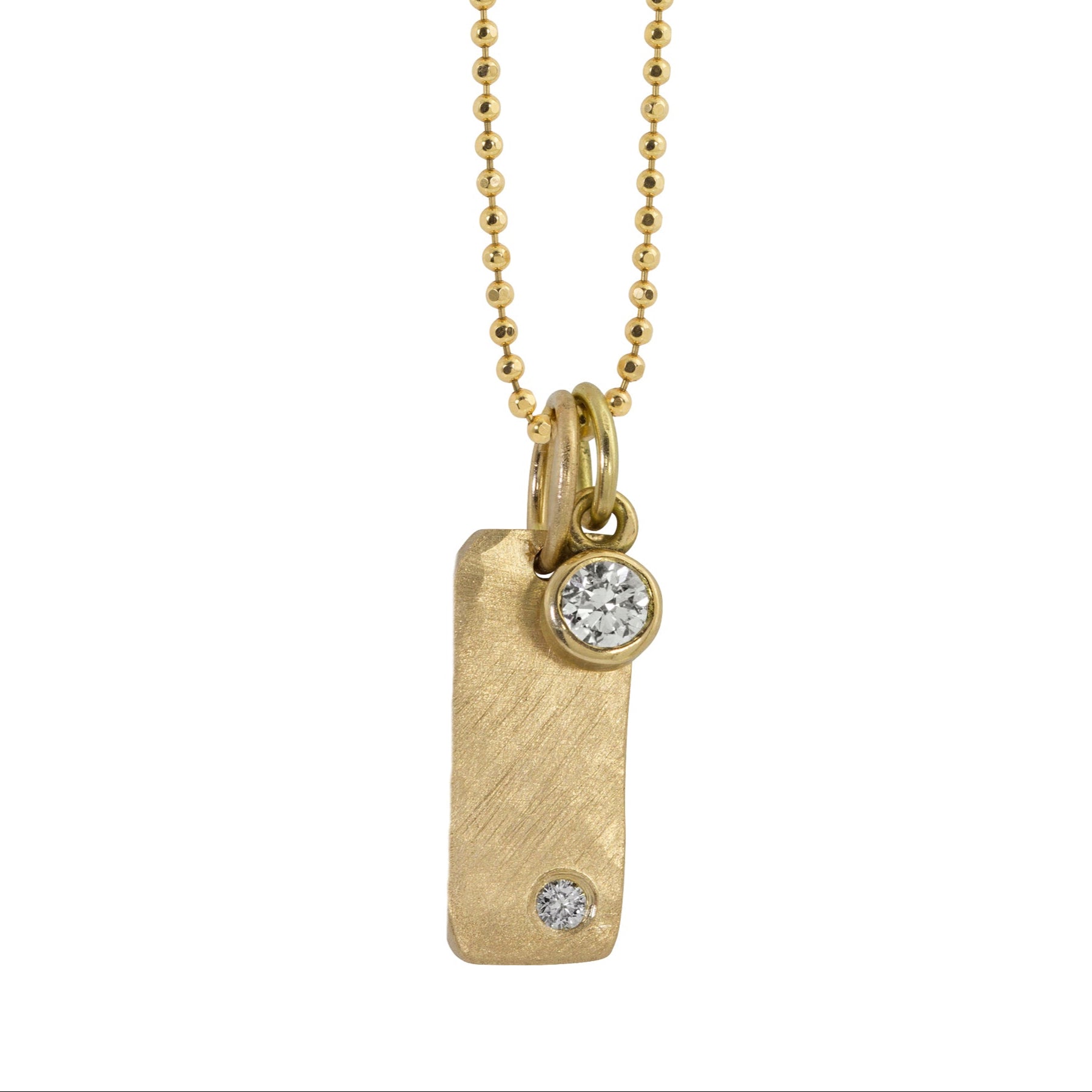 14k yellow gold bezel set white diamond charm on diamond cut ball chain paired with yellow gold niki bar charm on white background