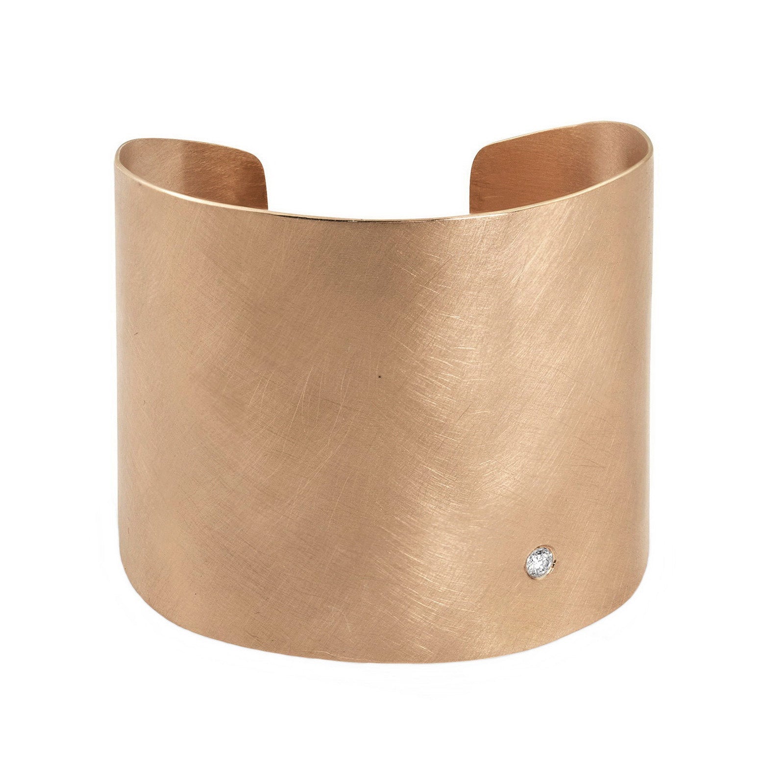 14k rose gold wide statement cuff with satin finish and single white diamond accent on white background