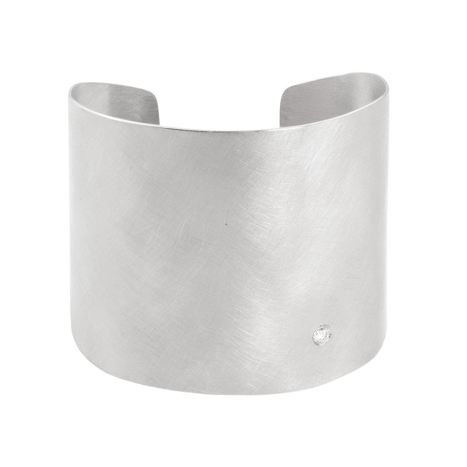 14k white gold wide statement cuff with satin finish and single white diamond accent on white background