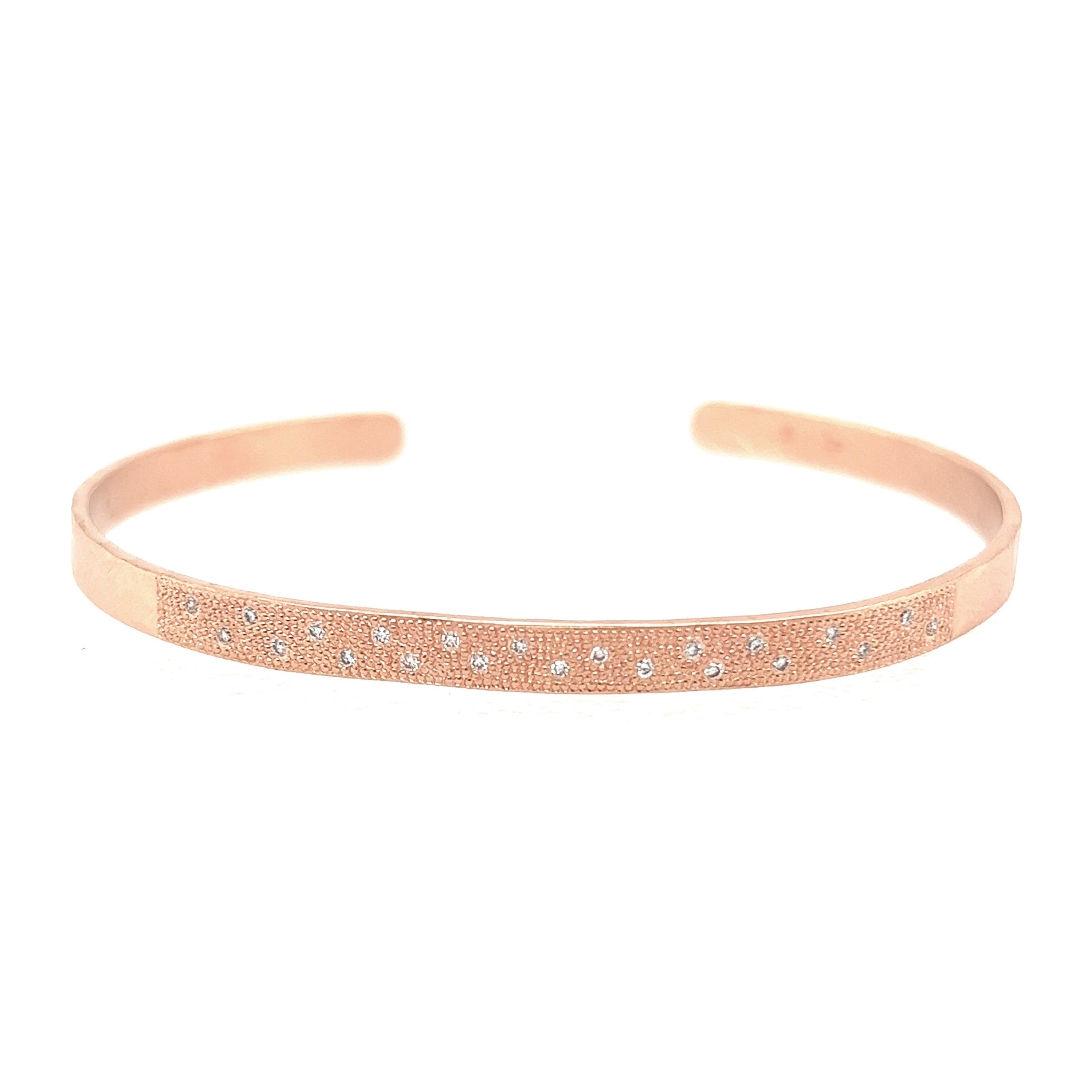 14k rose gold hammered cuff bracelet with beaded texture and scattered white diamonds on white background