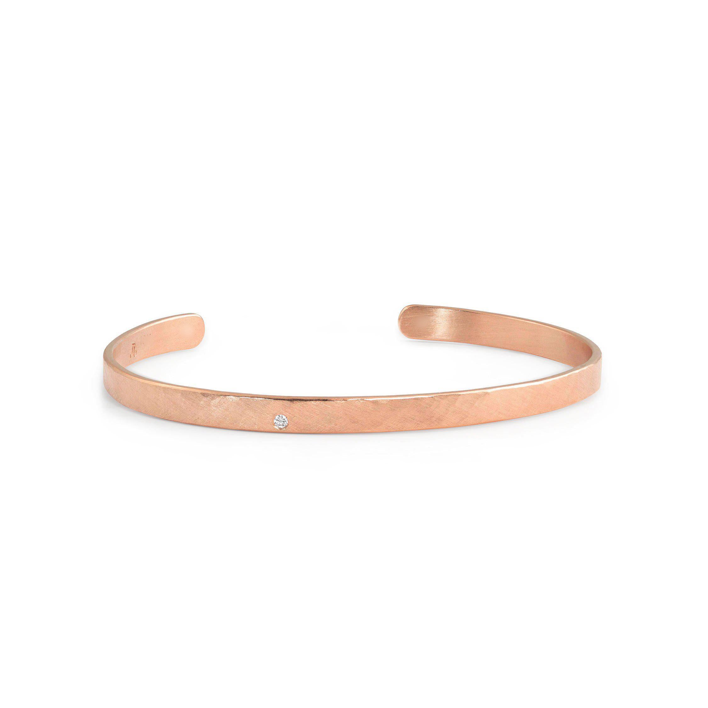 14k rose gold hammered open cuff bracelet with single white diamond accent on white background