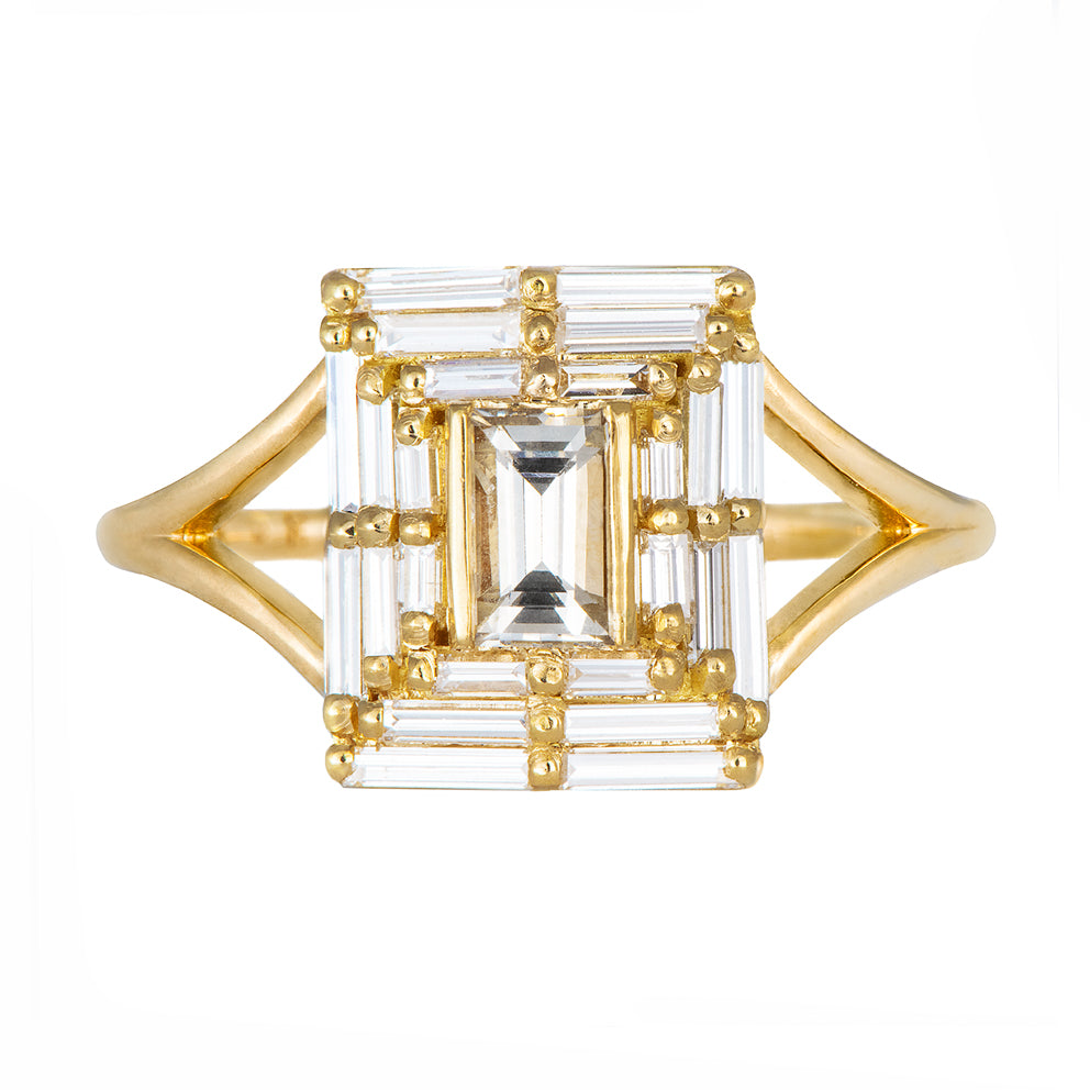 Gold ring with a clear gemstone on a white background