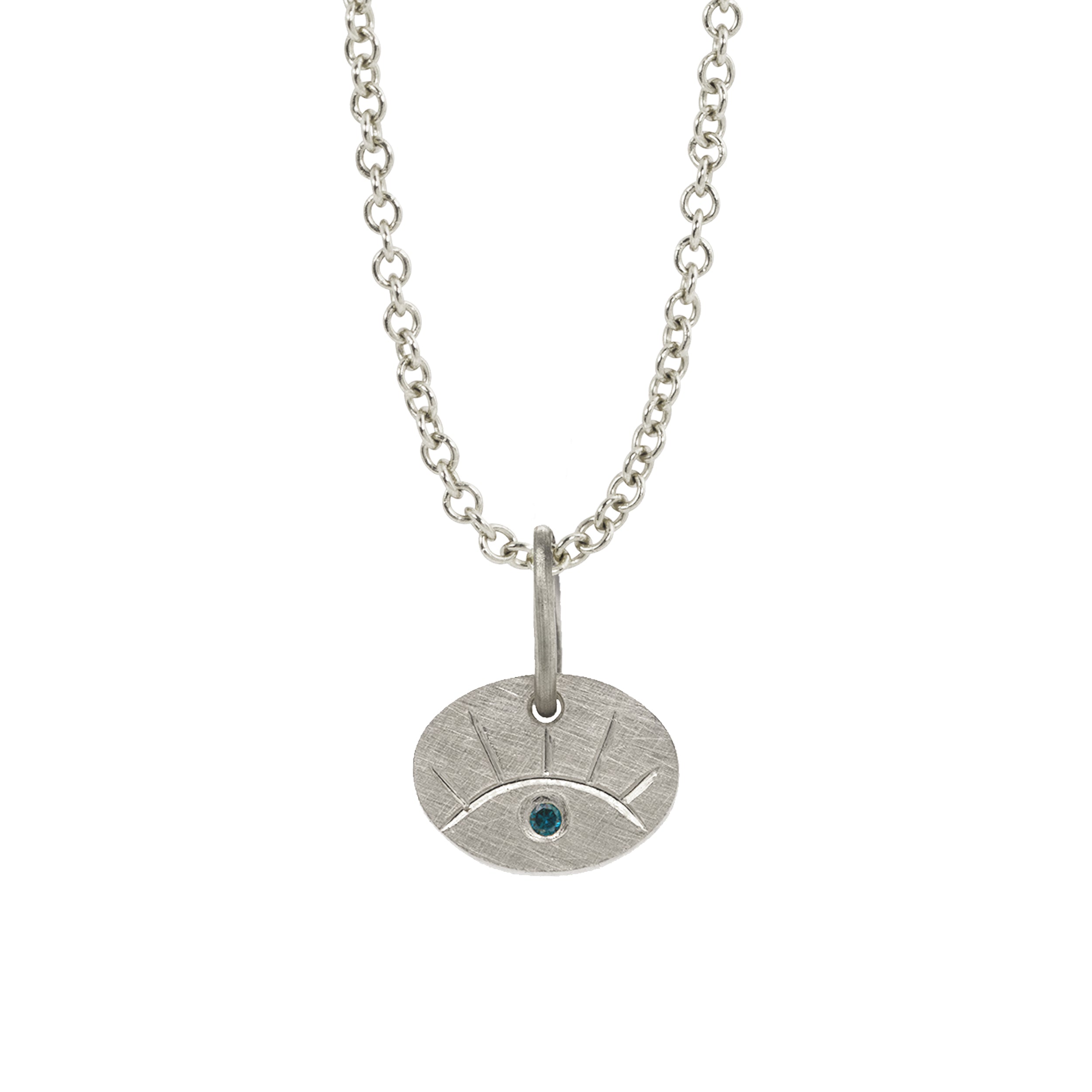 14k white gold eye pendant featuring hand etching and colored sapphire on a rolo chain on a white background