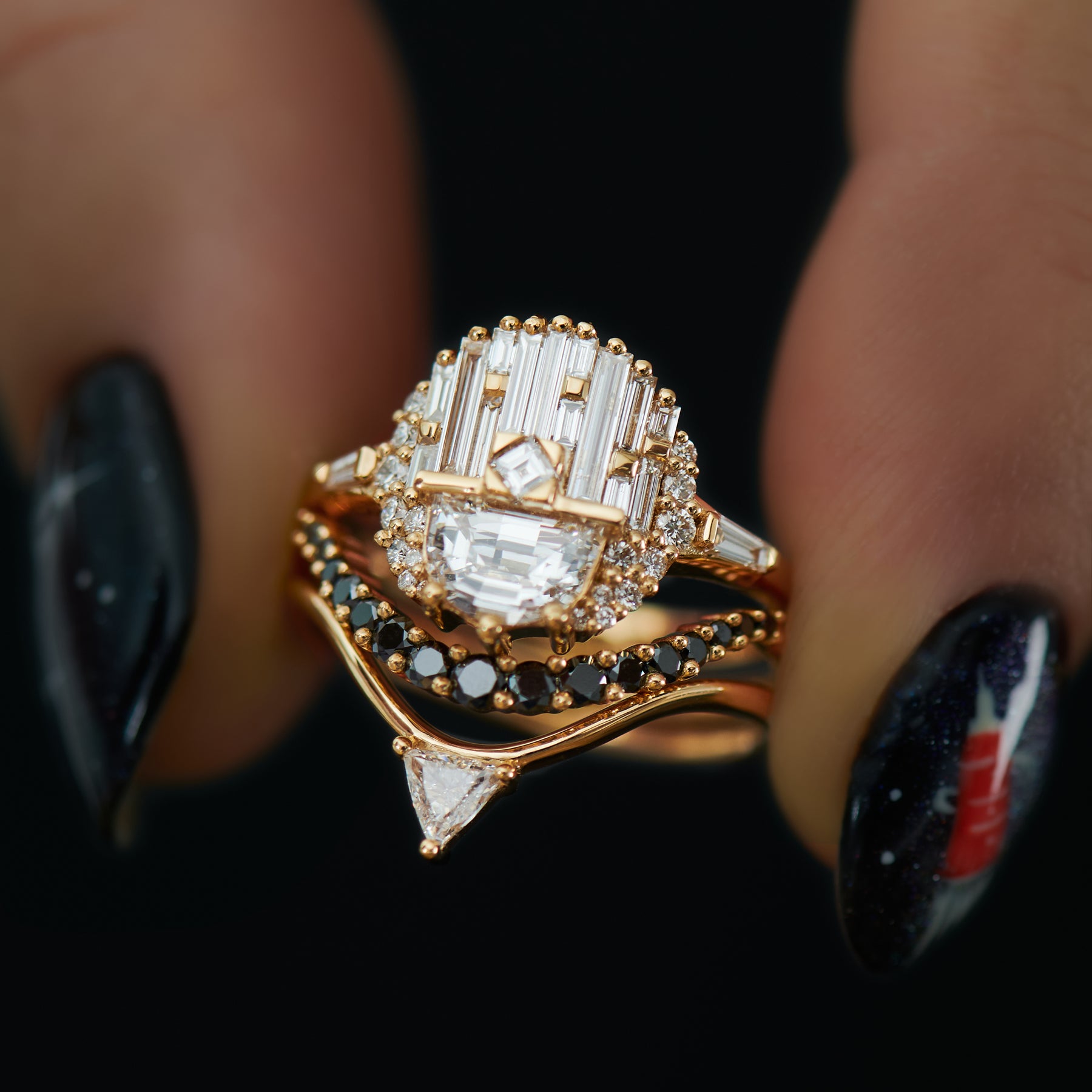Gold ring with diamond accents on a dark background