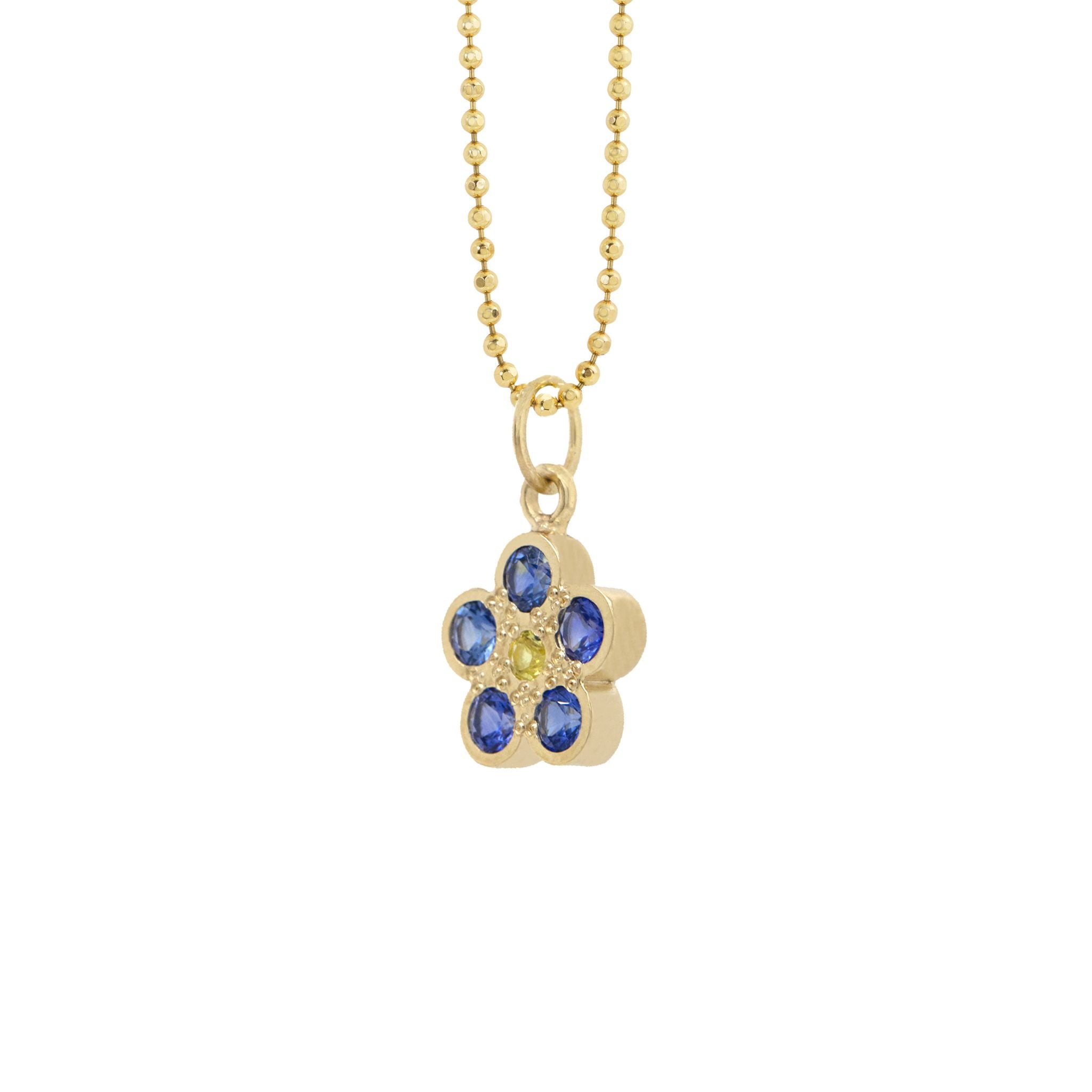 14k yellow gold flower-shaped pendant featuring blue and yellow stones on a diamond cut ball chain on a white background