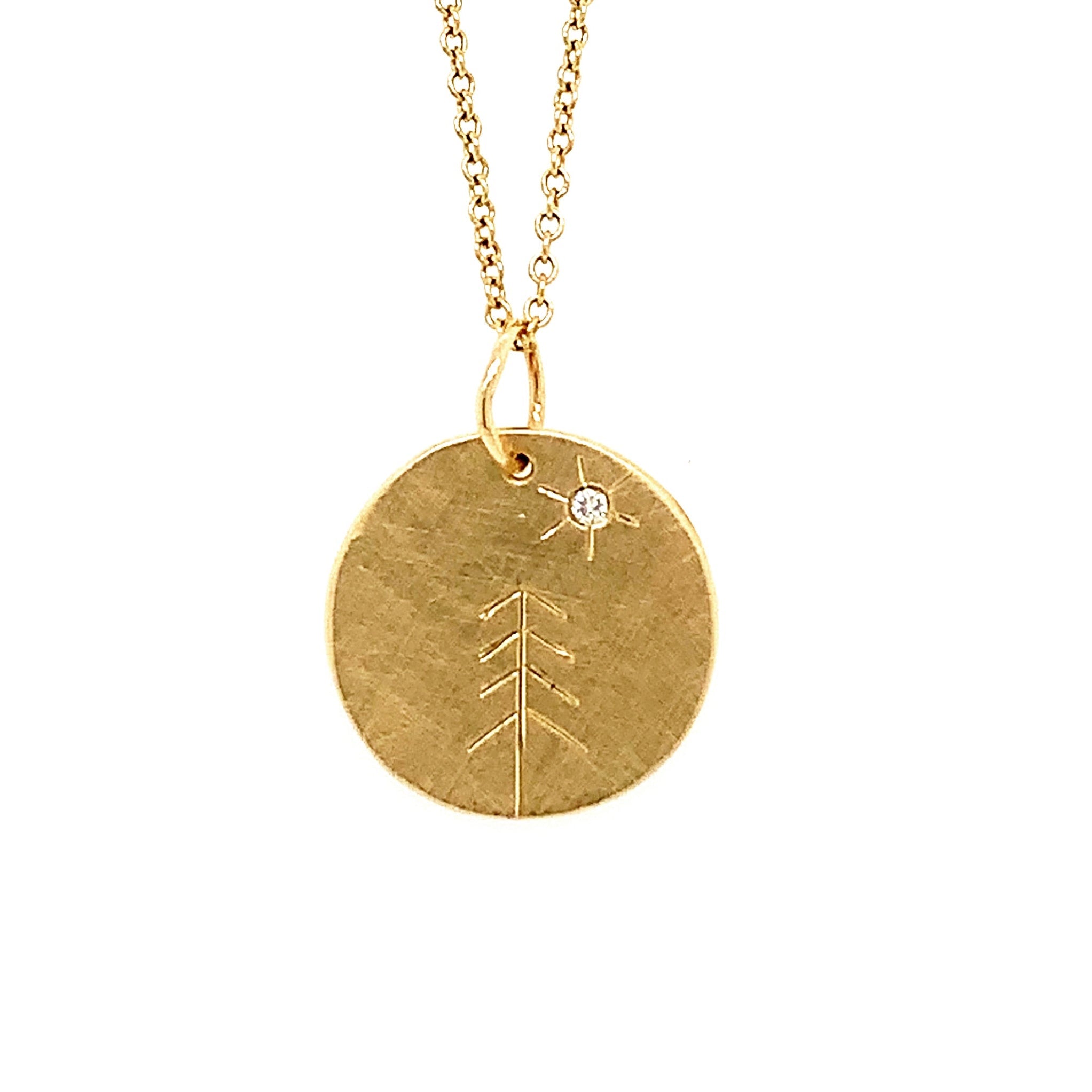 14k yellow gold round pendant featuring hand etched tree design and white diamond sunburst on rolo chain on a white background