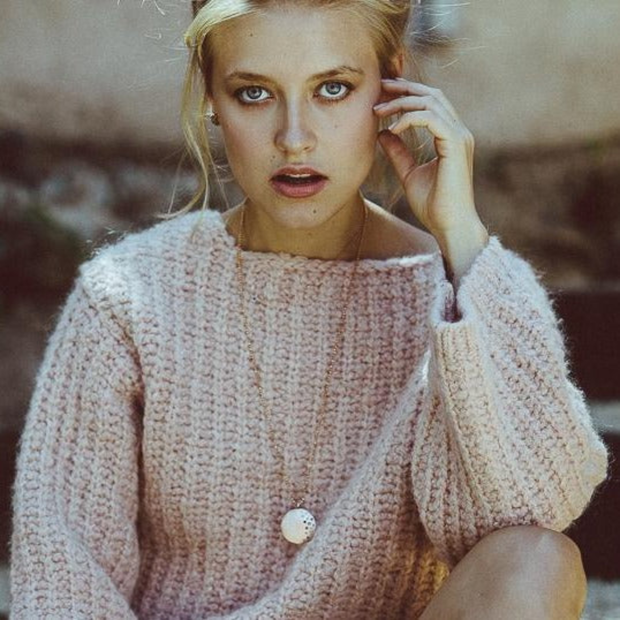 14k yellow gold round pendant with scattered white diamonds on model in lifestyle shot