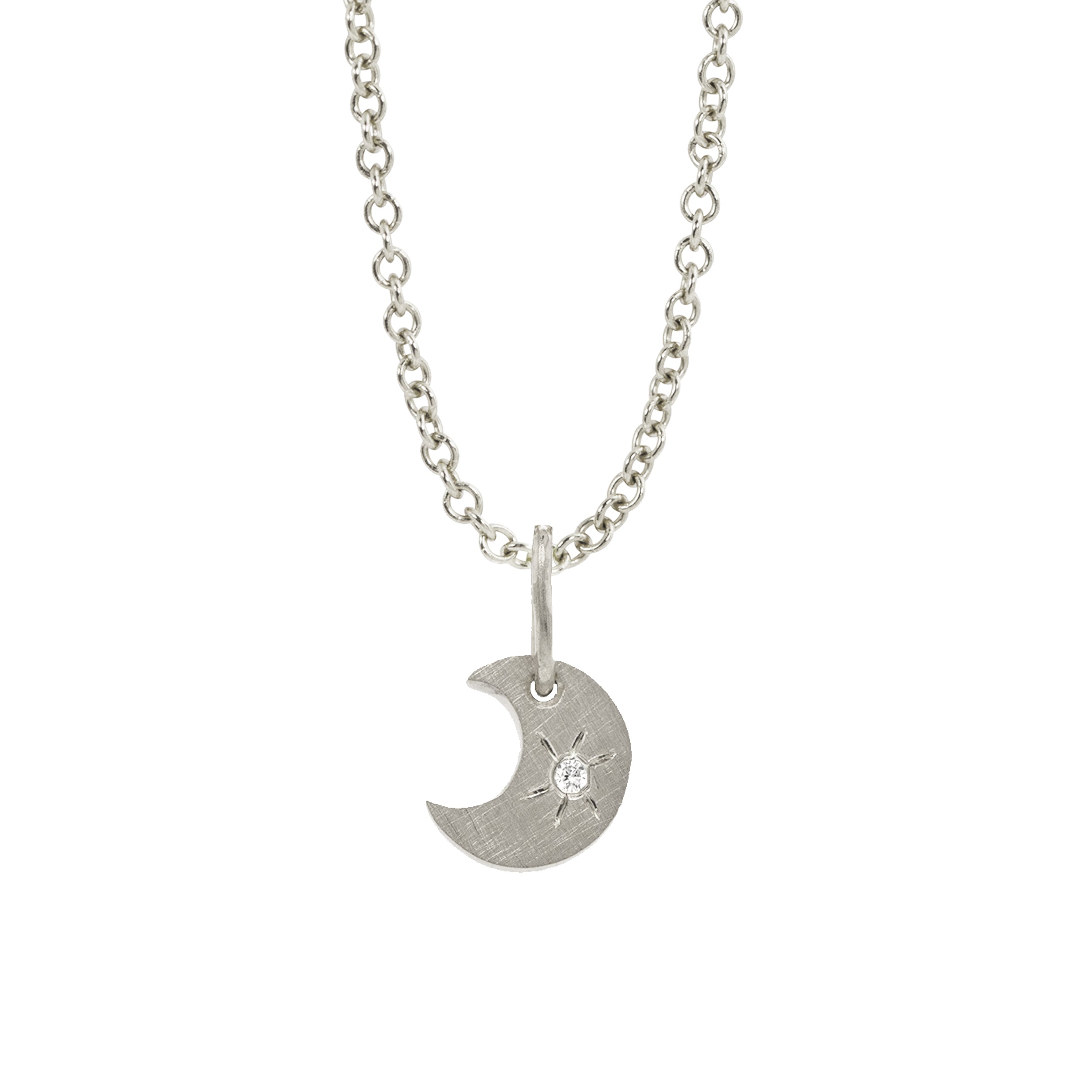 14k white gold crescent moon charm with a white diamond sunburst on a rolo chain on a white background