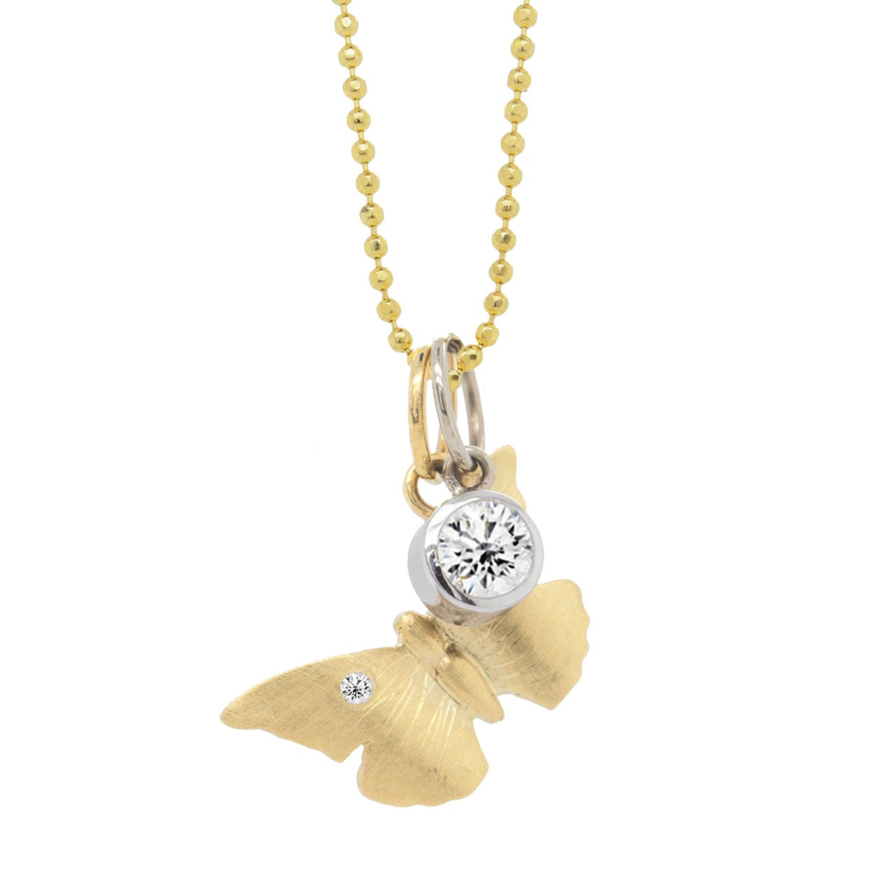 14k white gold bezel set diamond pendant stacked with yellow gold butterfly pendant with white diamond and hand etching on diamond cut ball chain on a white background