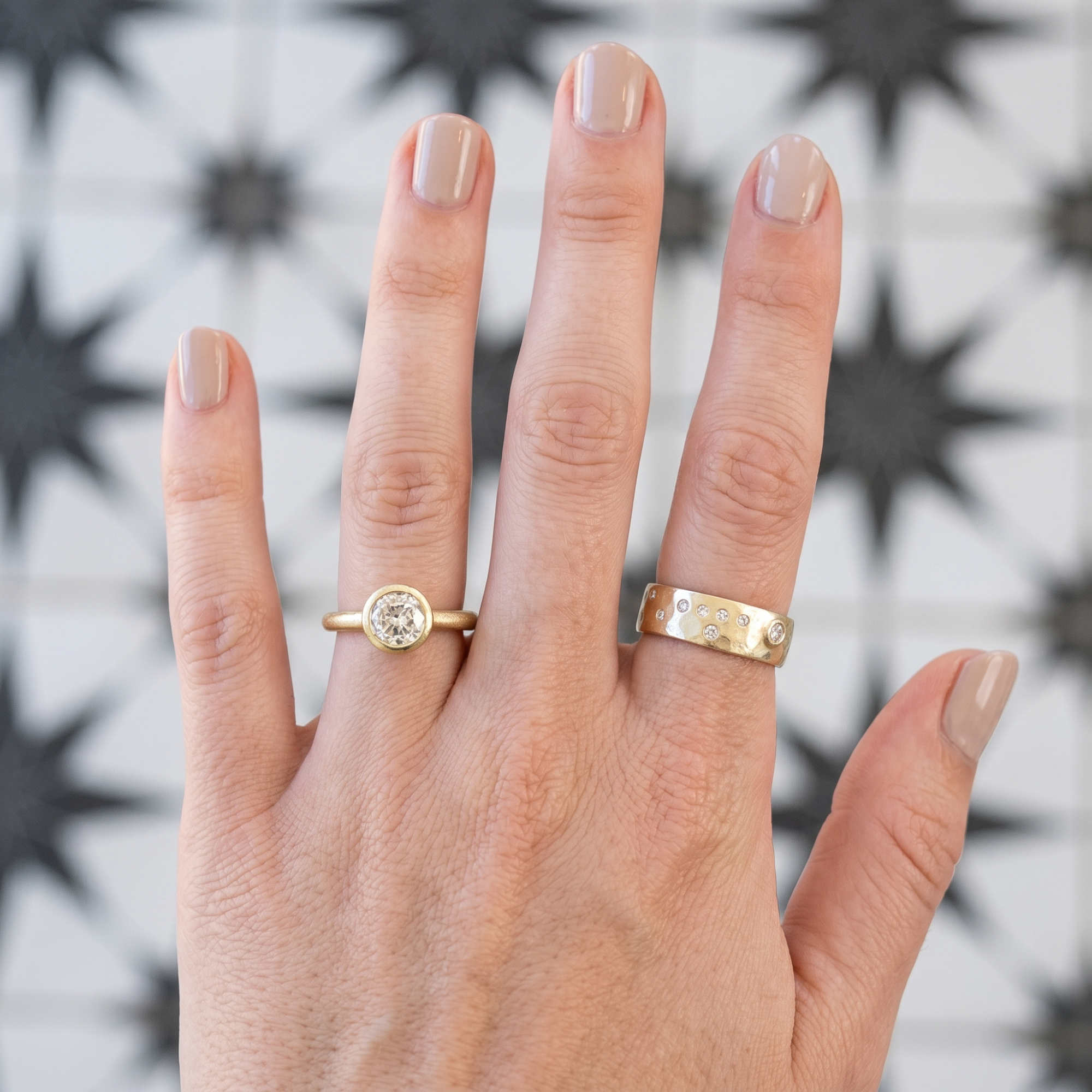 Old European cut round diamond bezel solitaire engagement ring in 14k gold, lifestyle shot worn on a model's hand