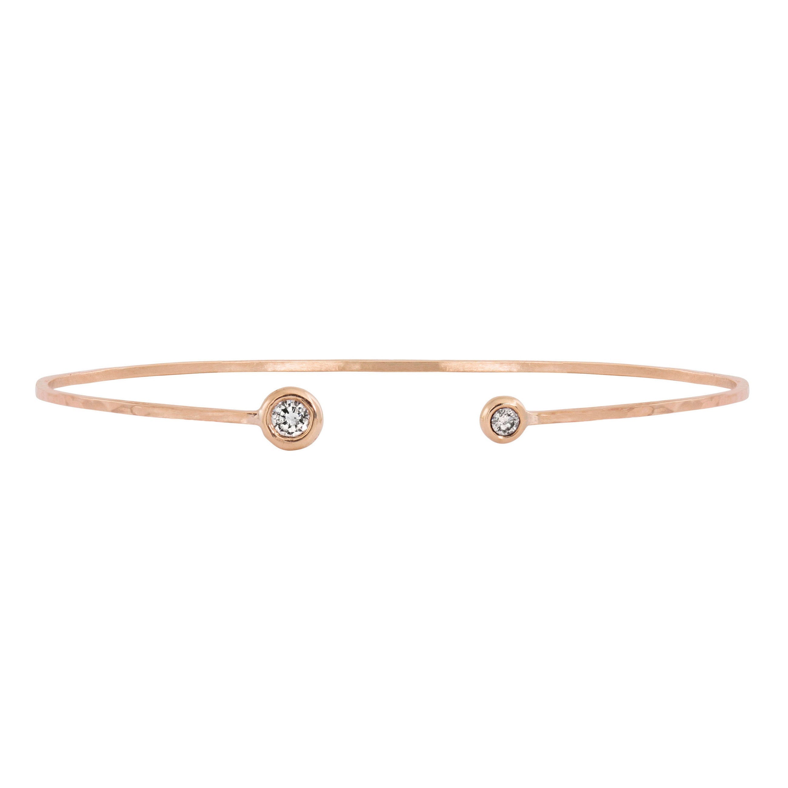 14k rose gold wire paddle bracelet with two bezel set white diamonds on white background