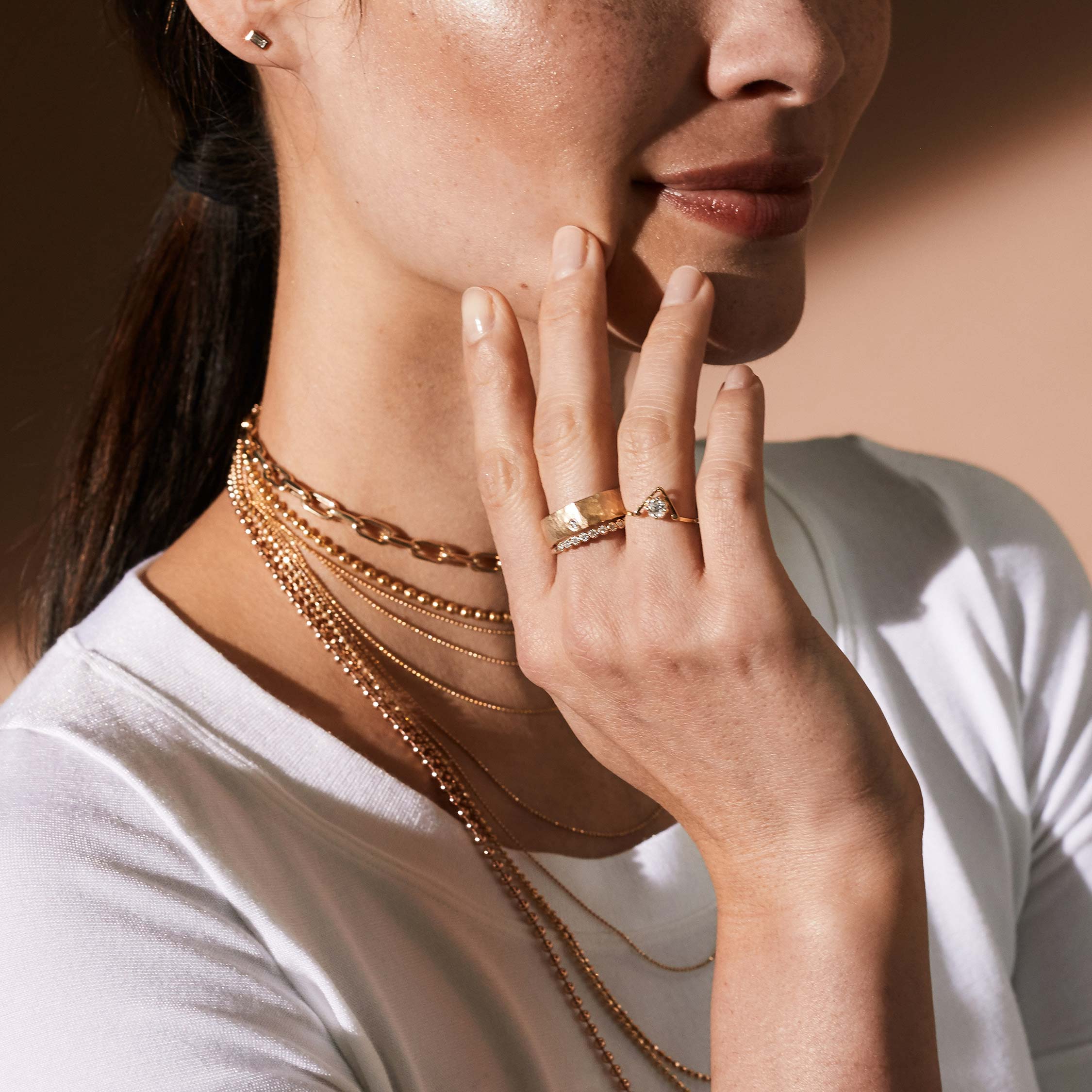 14k yellow gold half eternity ring with milgrain set white diamonds on model in lifestyle shot