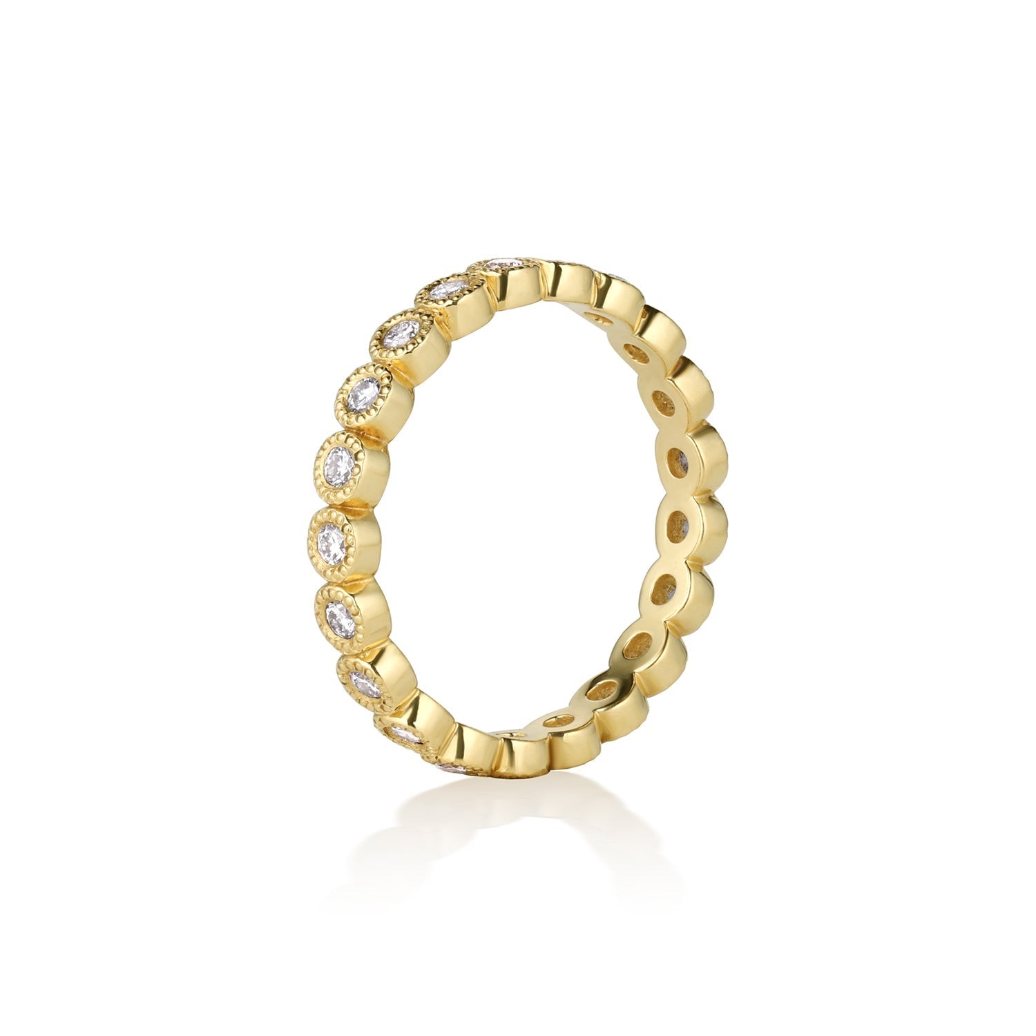 14k yellow gold milgrain white diamond eternity stacking ring on a white background side view