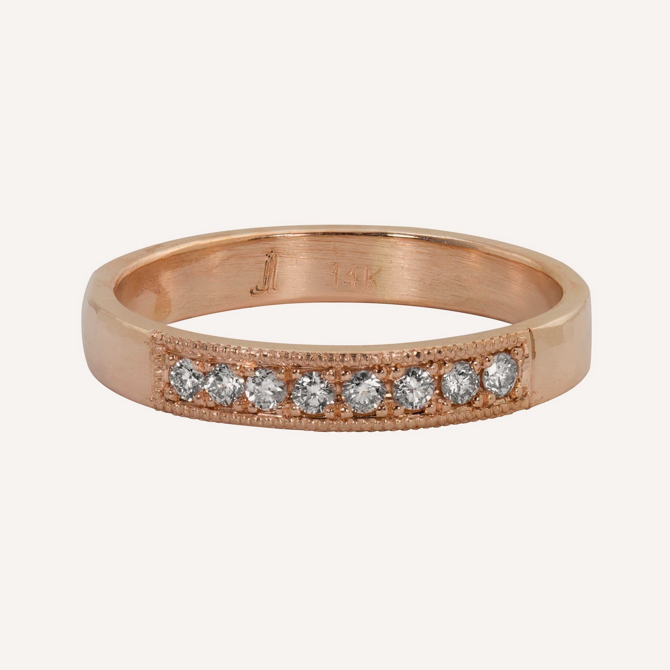 14k rose gold milgrain white diamond wedding band on white background