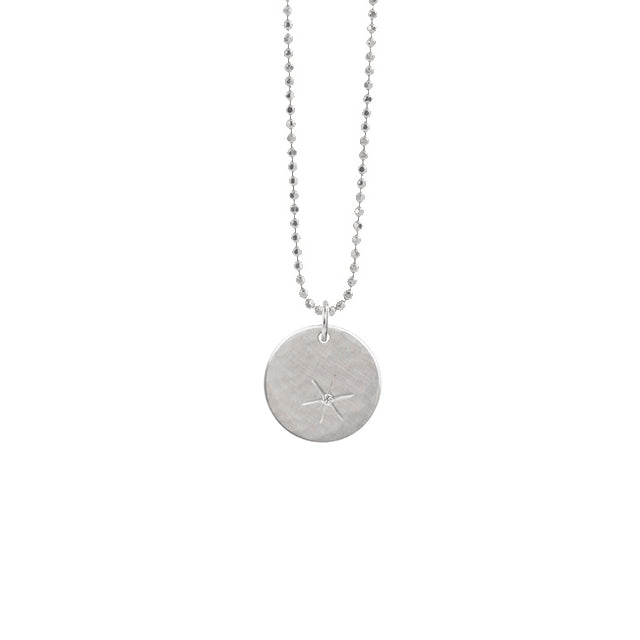 14k white gold round pendant with hand etched starburst with white diamond on diamond cut ball chain on a white background