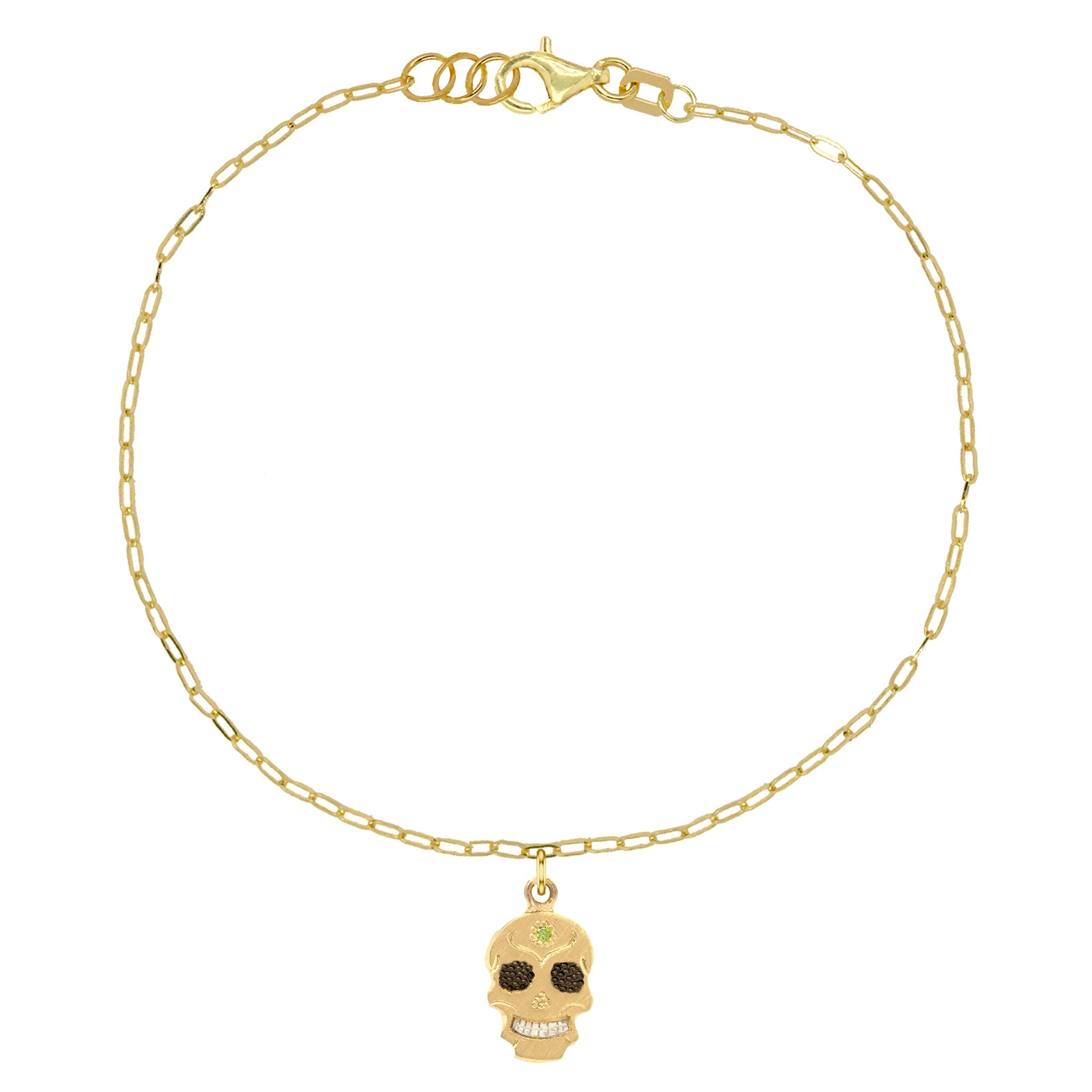 14k yellow gold teeny tiny ghostrider skull charm bracelet with colored gemstone and hand etching on paperclip link chain on white background
