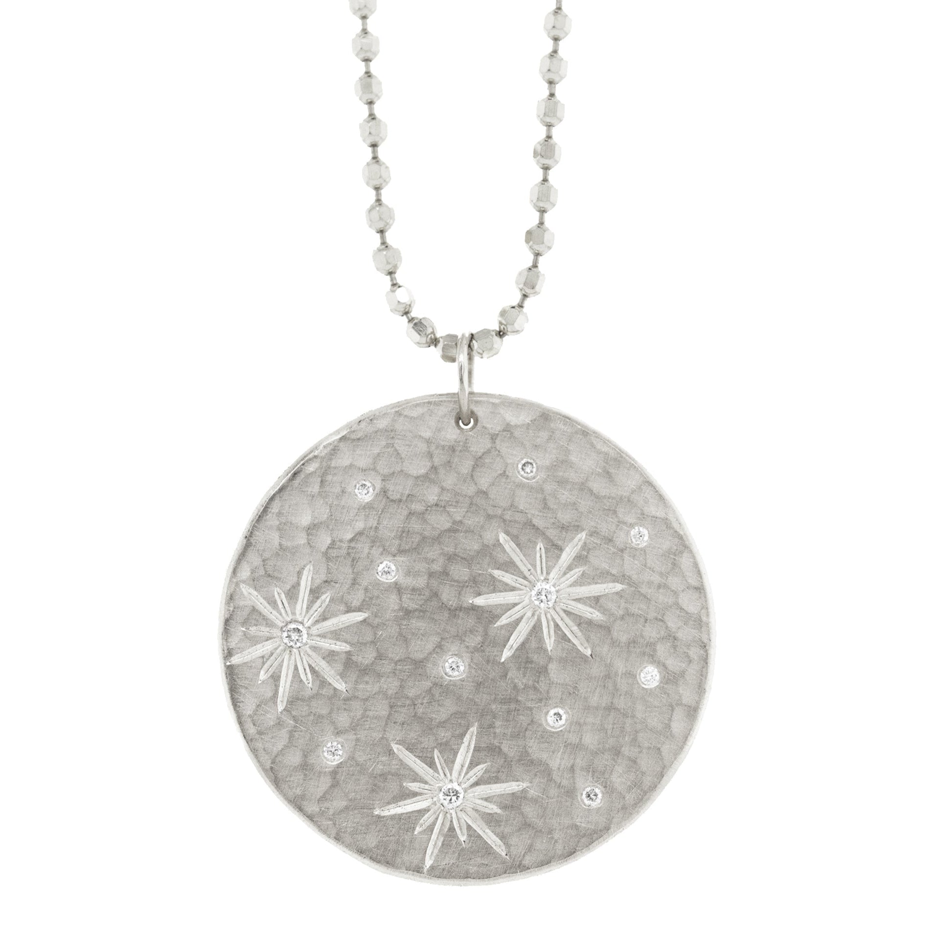 14k white gold round hammered pendant featuring hand etched starbursts with white diamonds on a white background
