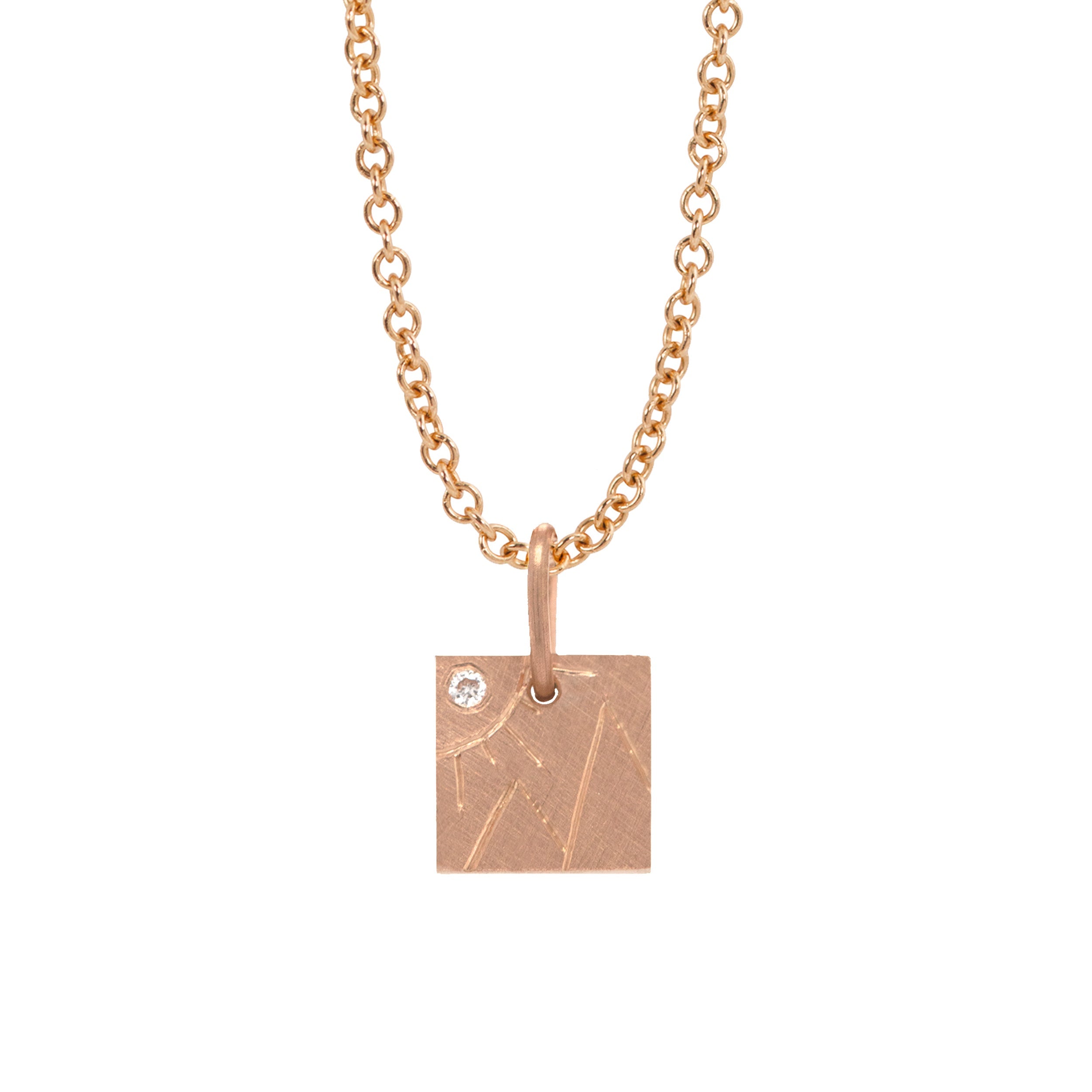 14k rose gold square pendant with hand etched mountains and sun with white diamond on a white background