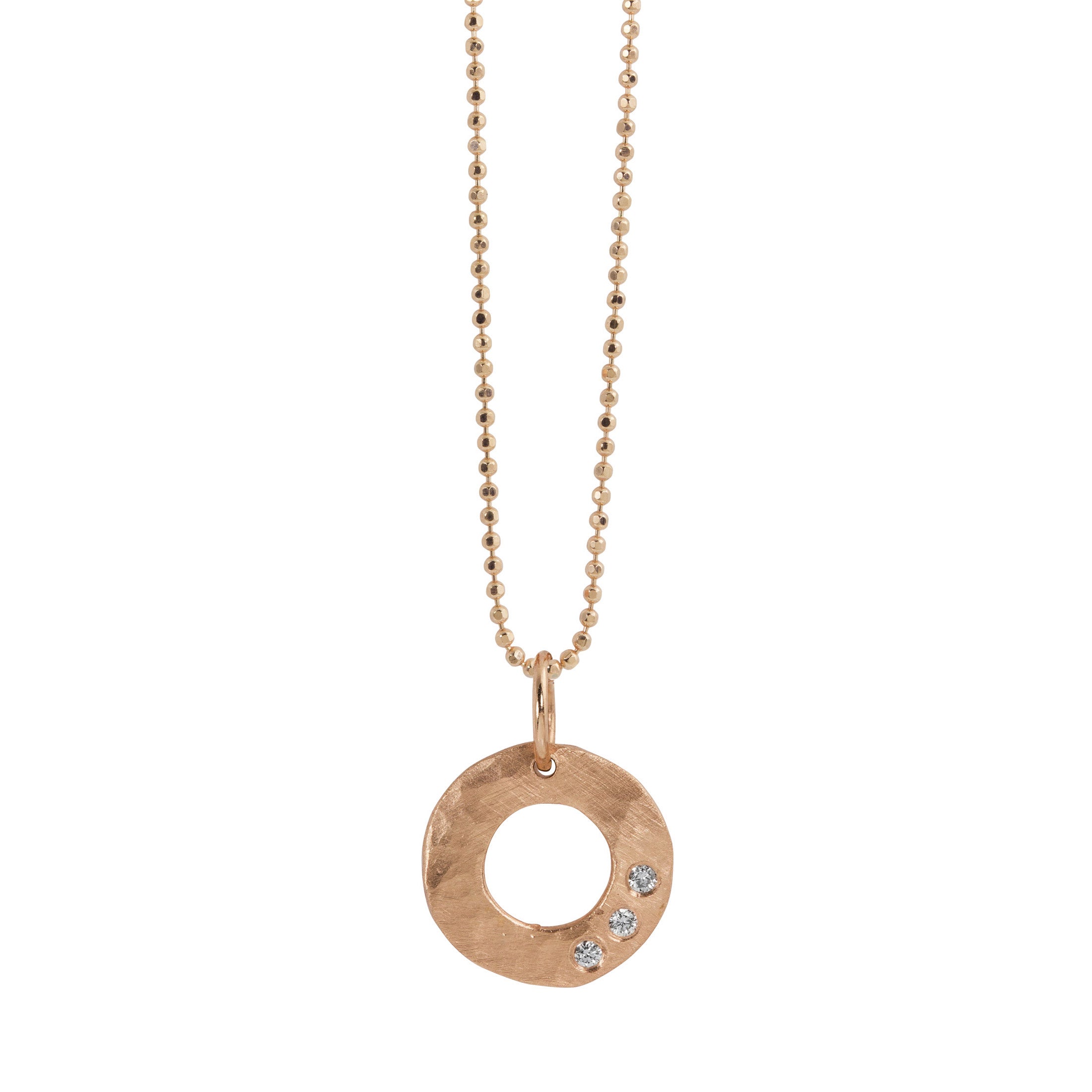 14k rose gold open circle pendant with hammered finish and three white diamonds on a white background