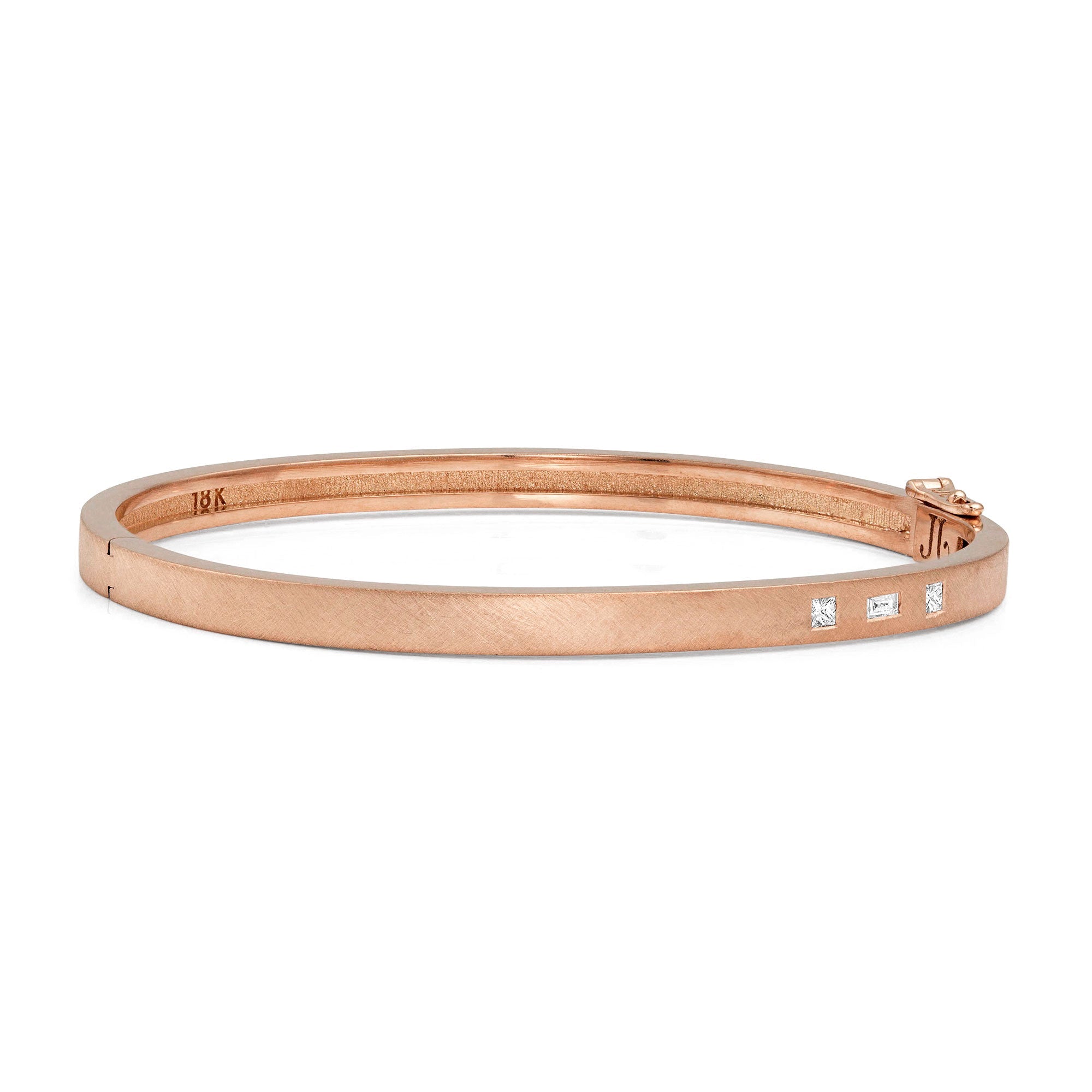 18k rose gold hinged bangle bracelet with baguette and princess cut white diamonds on white background