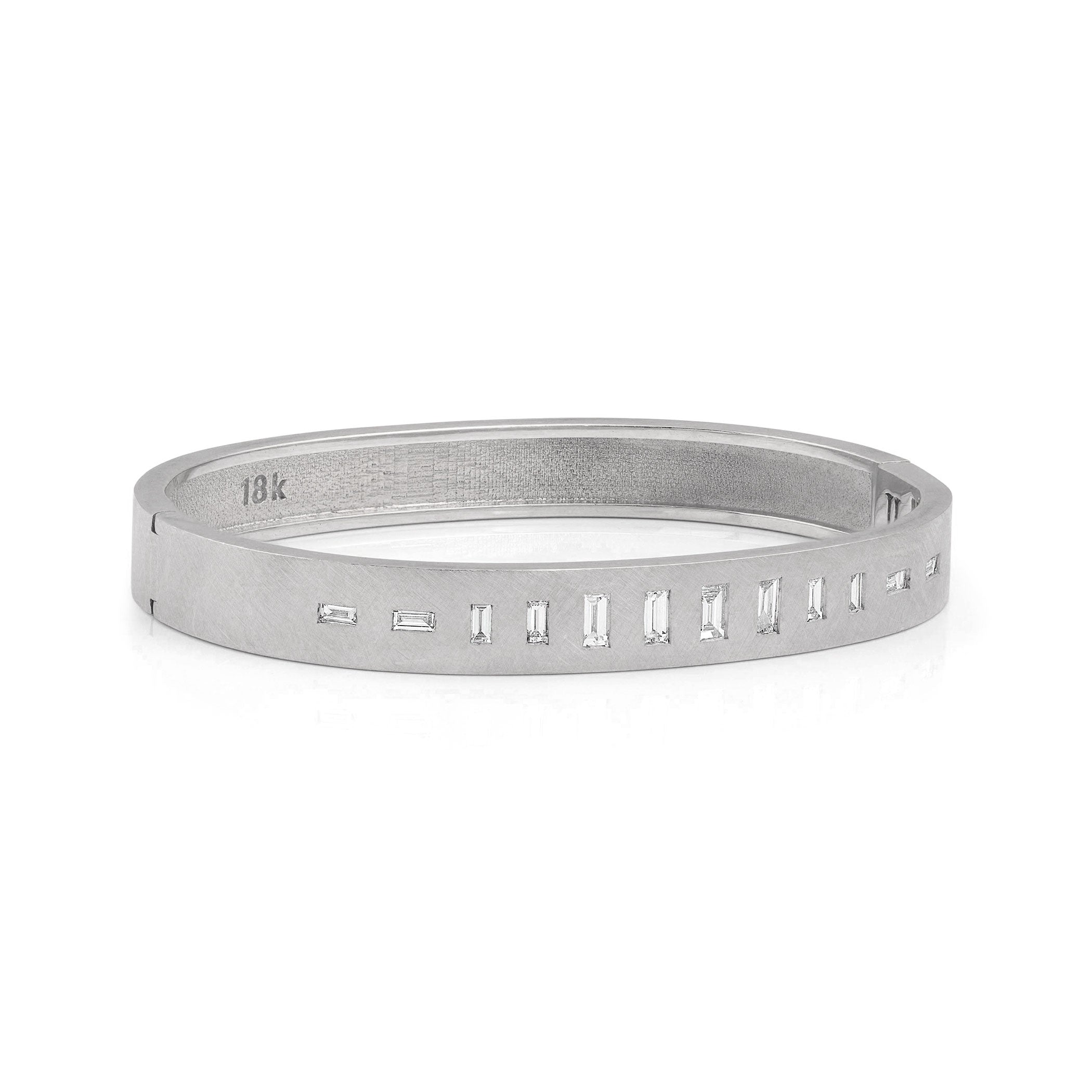 18k white gold hinged bangle bracelet with baguette cut white diamonds on white background