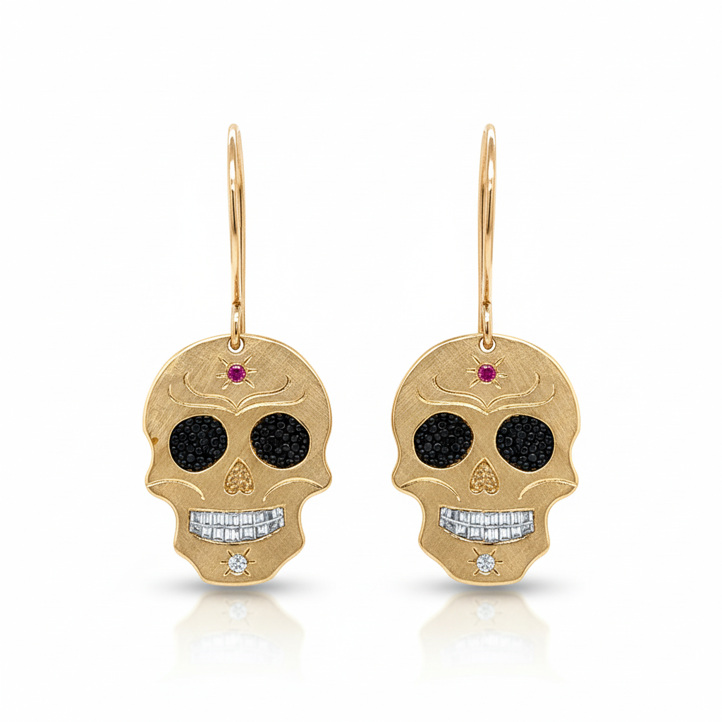 14k Gold skull shaped earrings with black diamond eyes and red gemstones on a white background