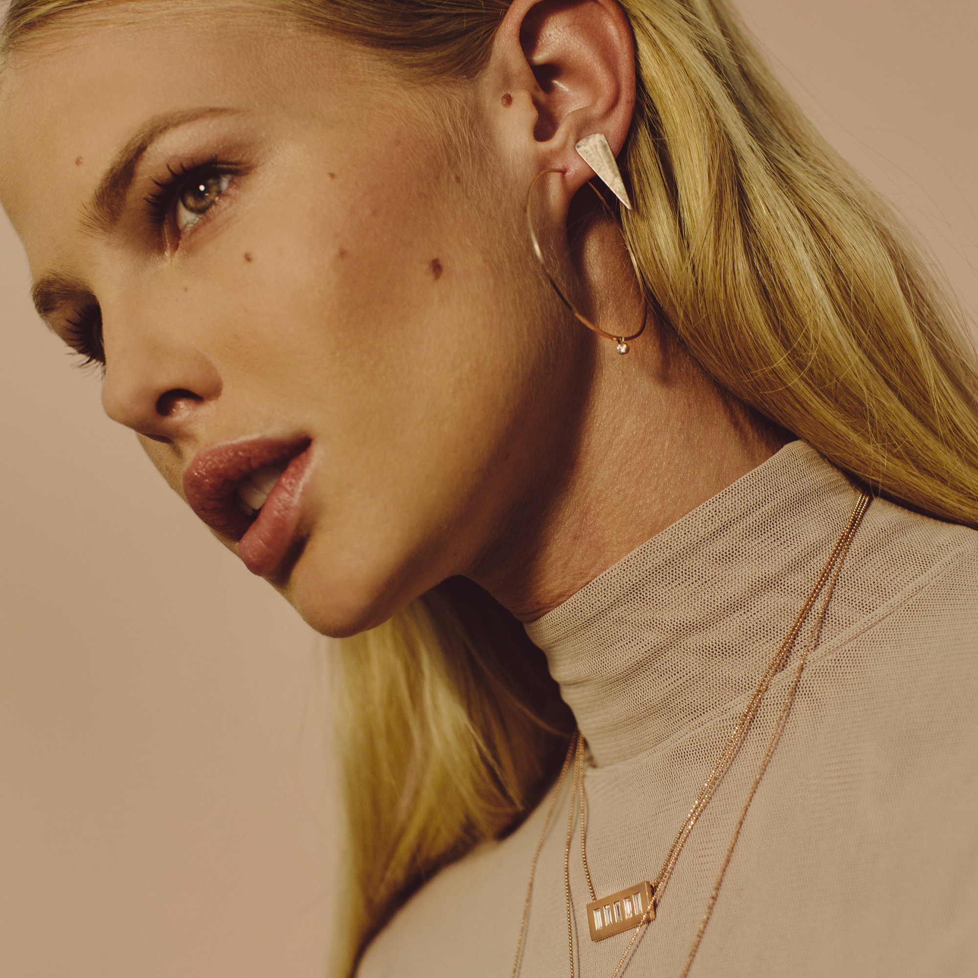 14k gold baby diamond bezel hoop charms on orms hoops on model in lifestyle shot