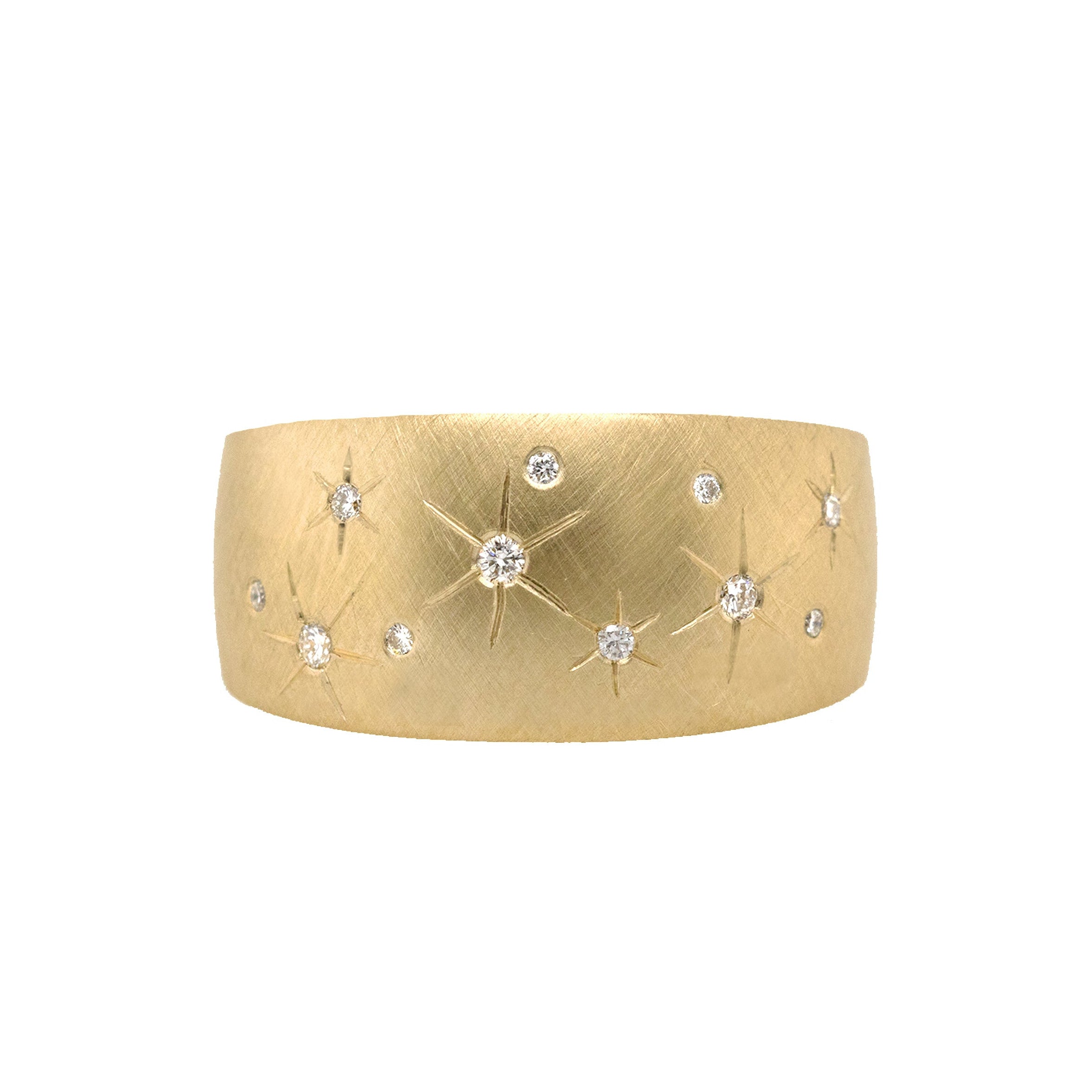 14k gold puffed wide band ring with scattered engraved diamond star on white background