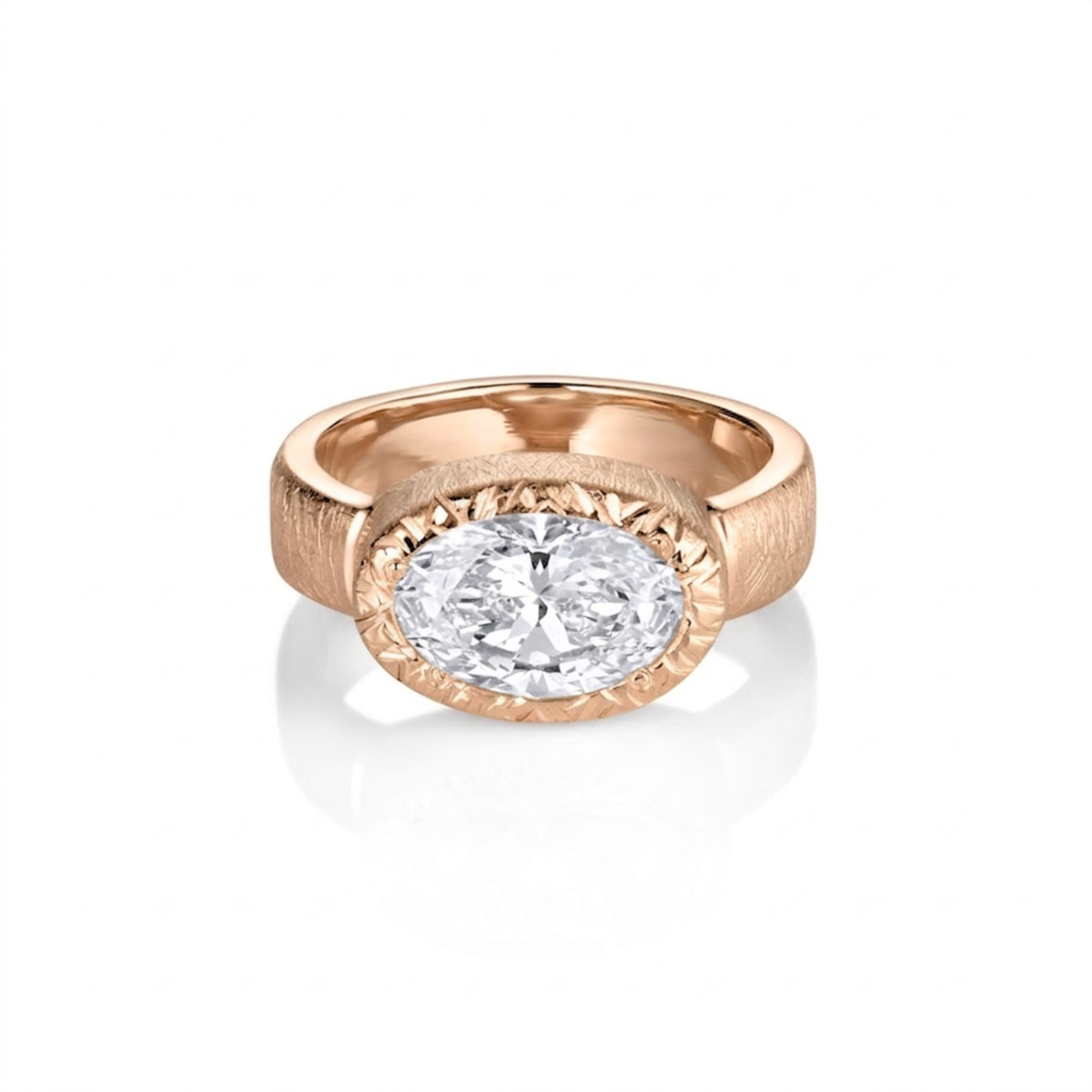 Chunky wide band east-west oval bezel solitaire diamond engagement ring with textured finish in 14k rose gold on a white background