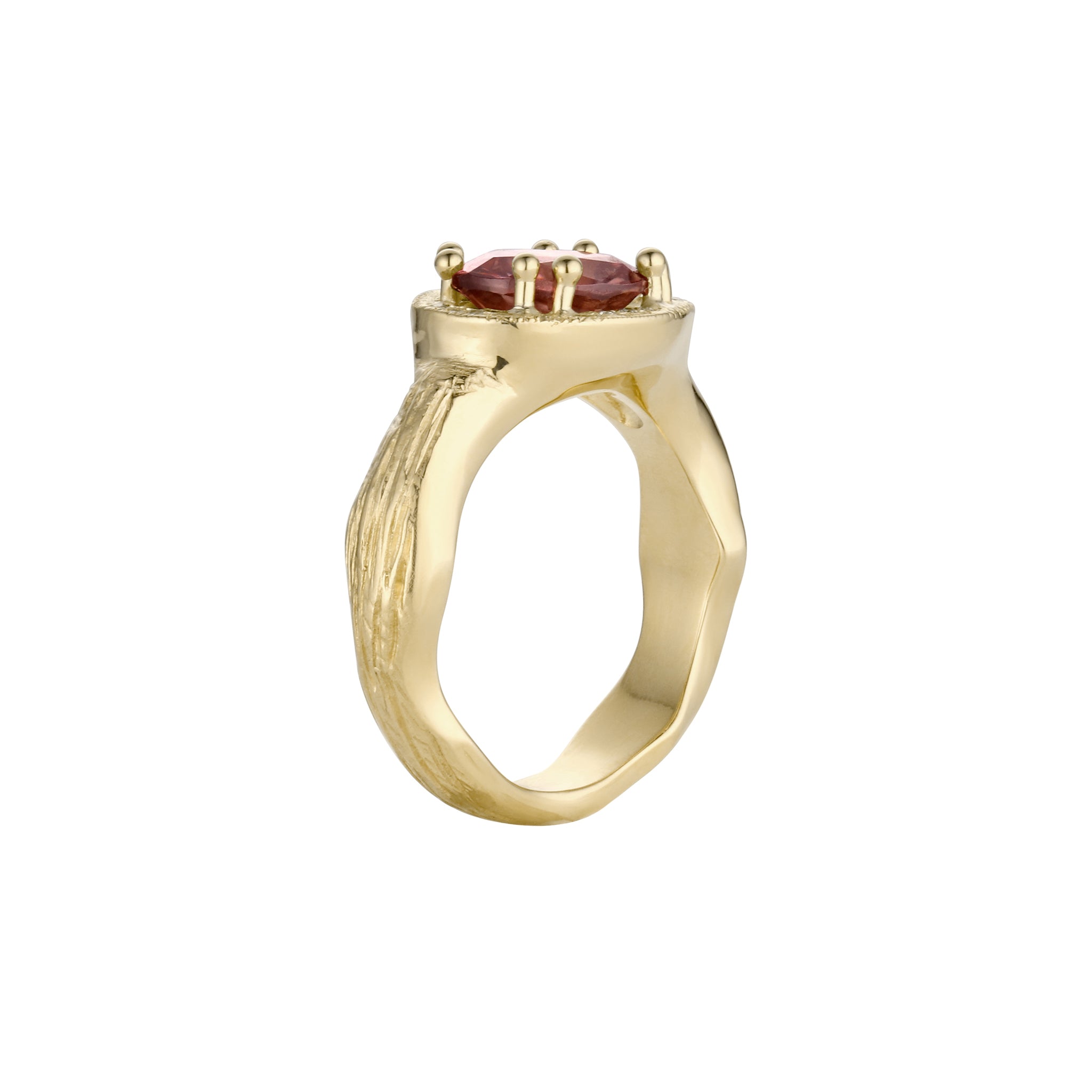 Gold ring with a pink zircon gemstone profile view on a white background