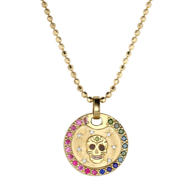 Gold necklace with a colorful pendant featuring a skull design and rainbow gradient sapphire border. White diamond starburst accents. Shown on thick diamond cut ballchain on a white background.