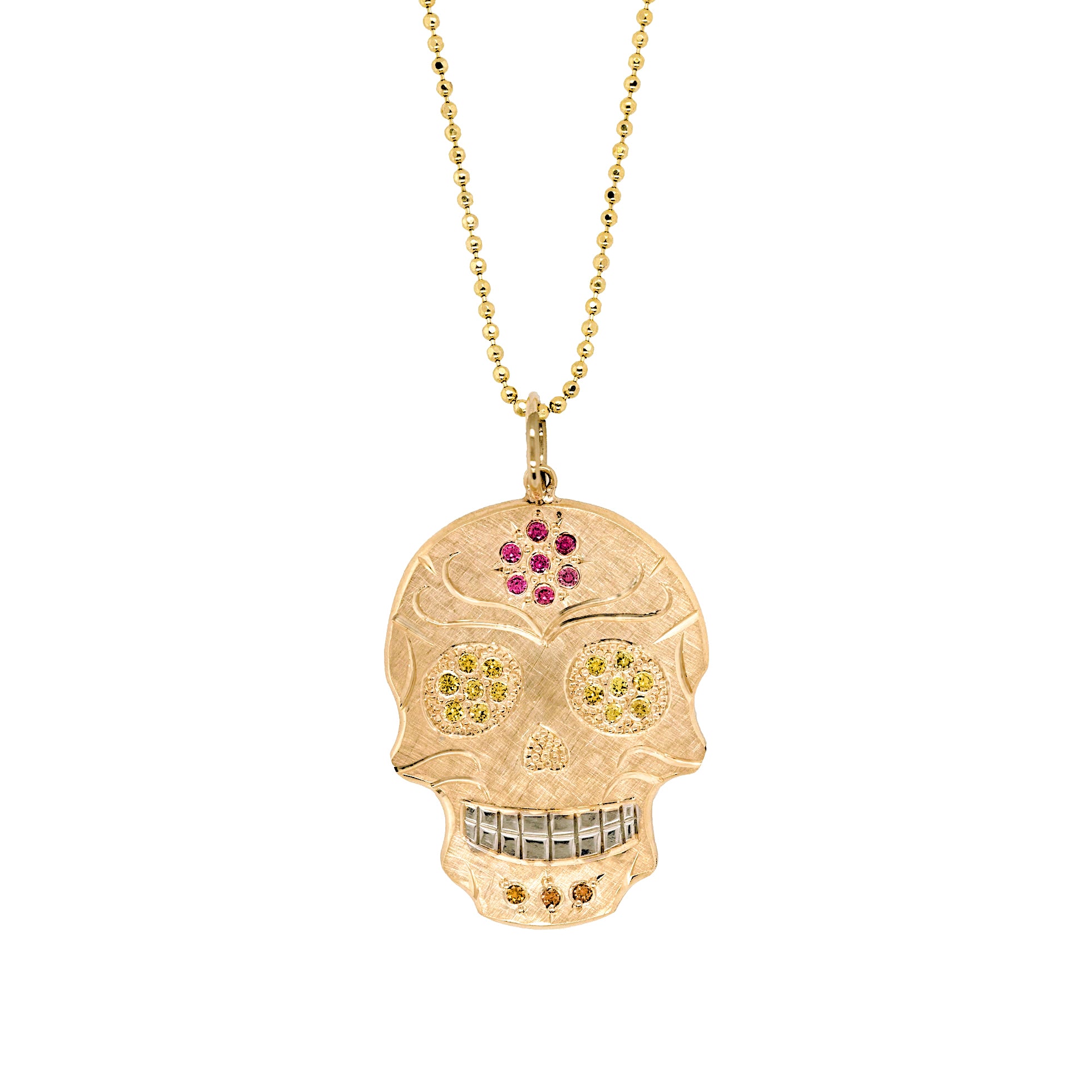 14k gold handcut sugar skull pendant with gemstone details hand engraving and rhodium brightened teeth shown on chain on white background