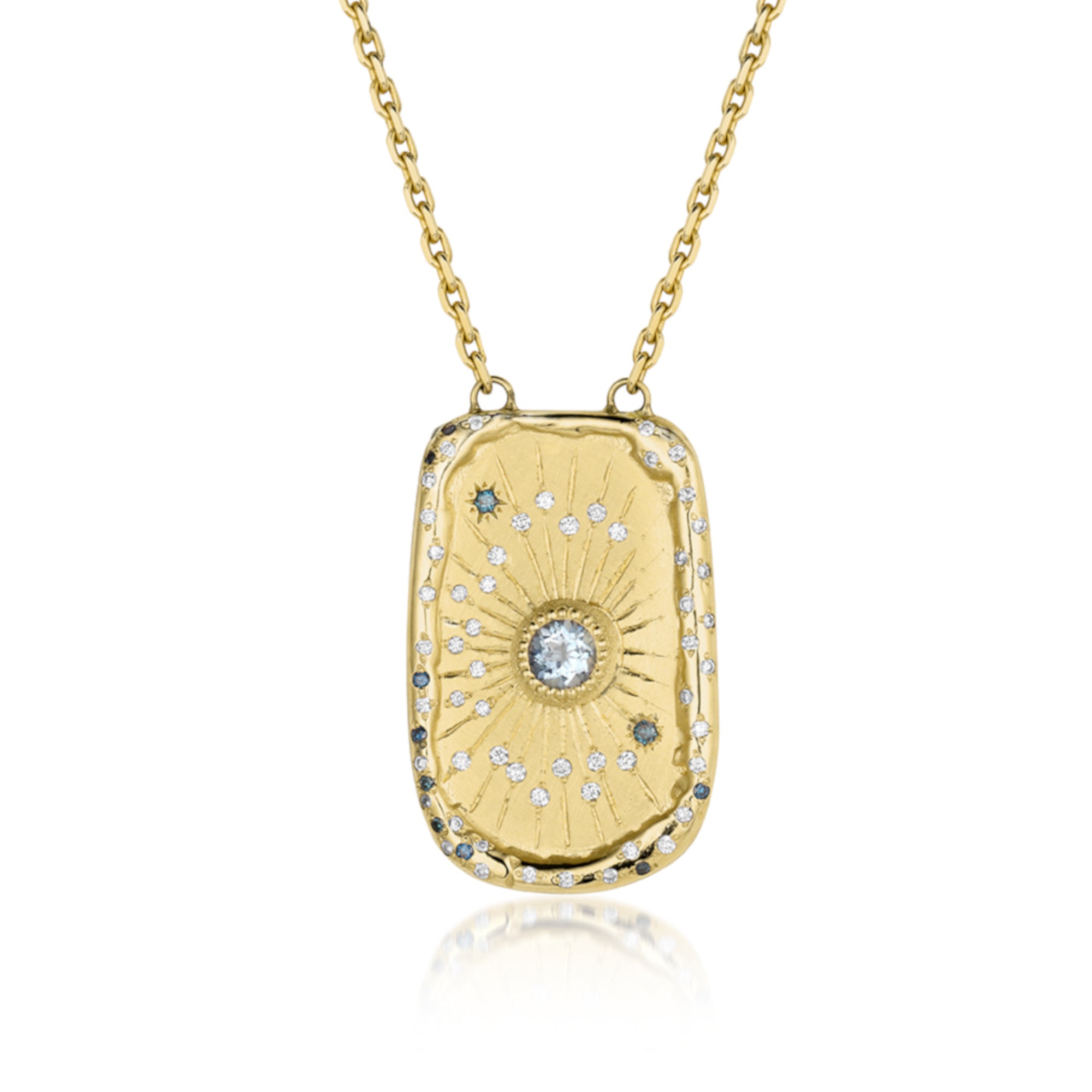 Large 14k gold rectangular pendant necklace with white Diamonds. Cosmic motif with bezel set blue sapphire, Flush set white and teal diamonds stars with hand engraved radiating rays.. Pave diamond bale hanging on a round link chain, on a white background.