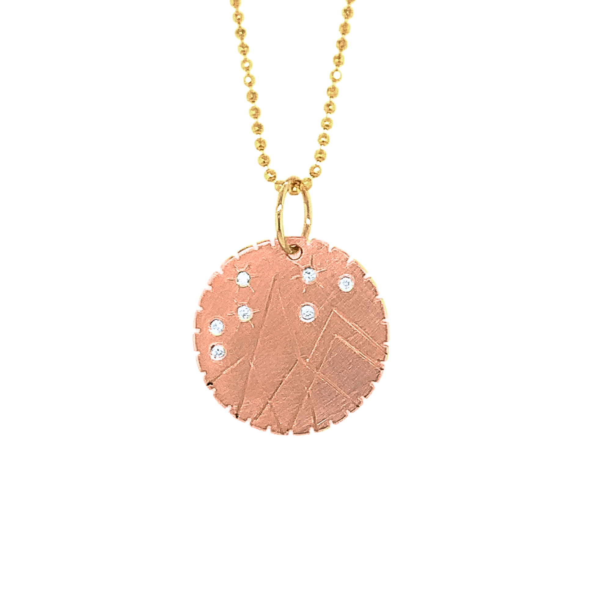 14k rose gold round pendant with hand etched mountains and white diamond starbursts on a white background