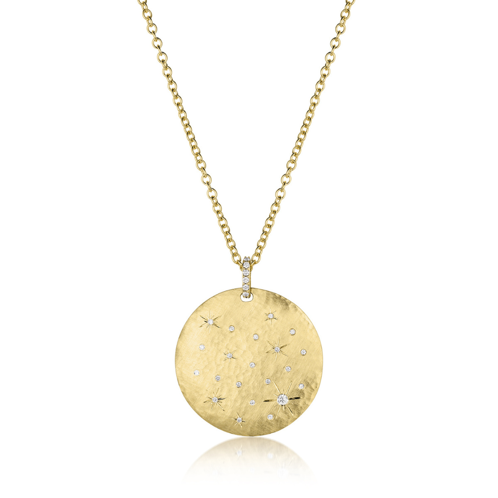 Extra large gold necklace with a round pendant featuring clustered white diamond star designs on a white background