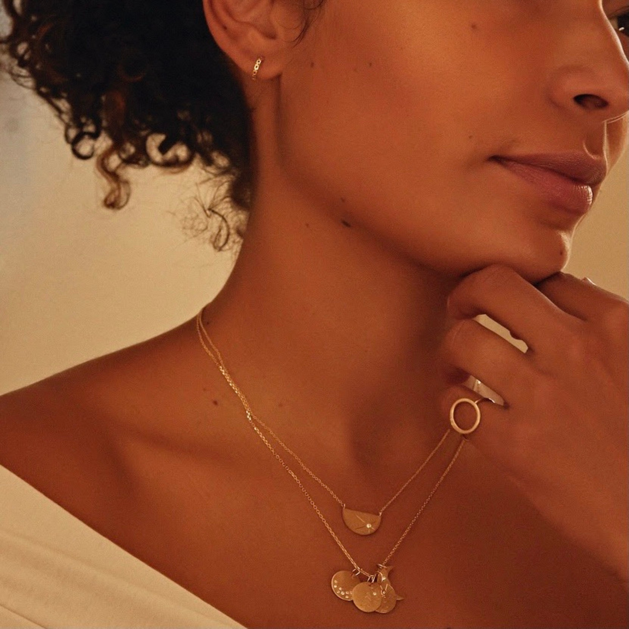 14k yellow gold chain link pattern hoop earrings on model in lifestyle shot