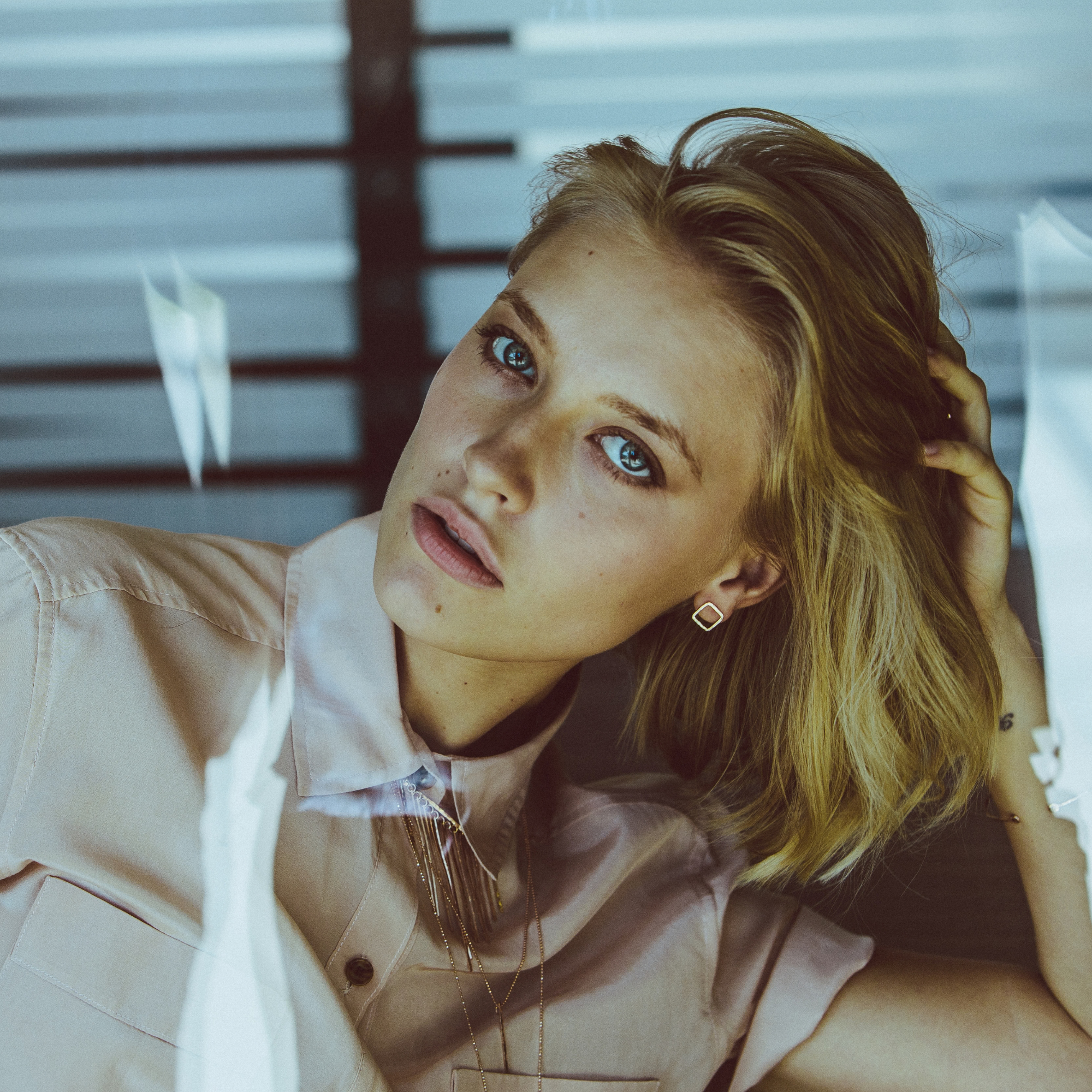 14k yellow gold open square hammered post earrings on model in lifestyle shot