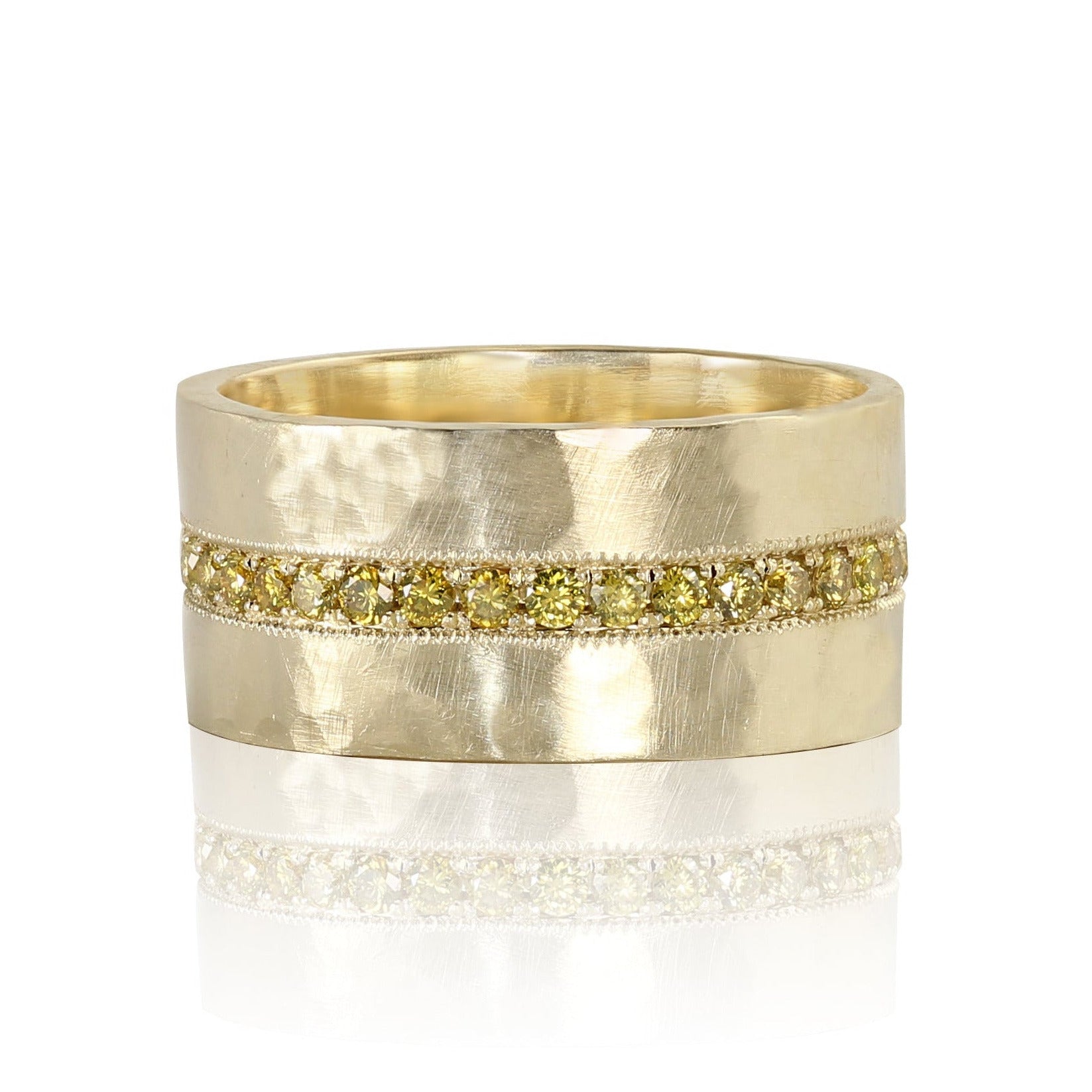 Wide 14k gold ring with a hammer textured band and embedded yellow stones eternity band on a white background