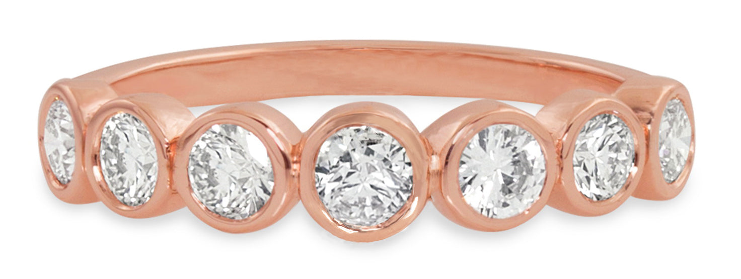 Rose gold ring with bezel set round white diamonds on white background