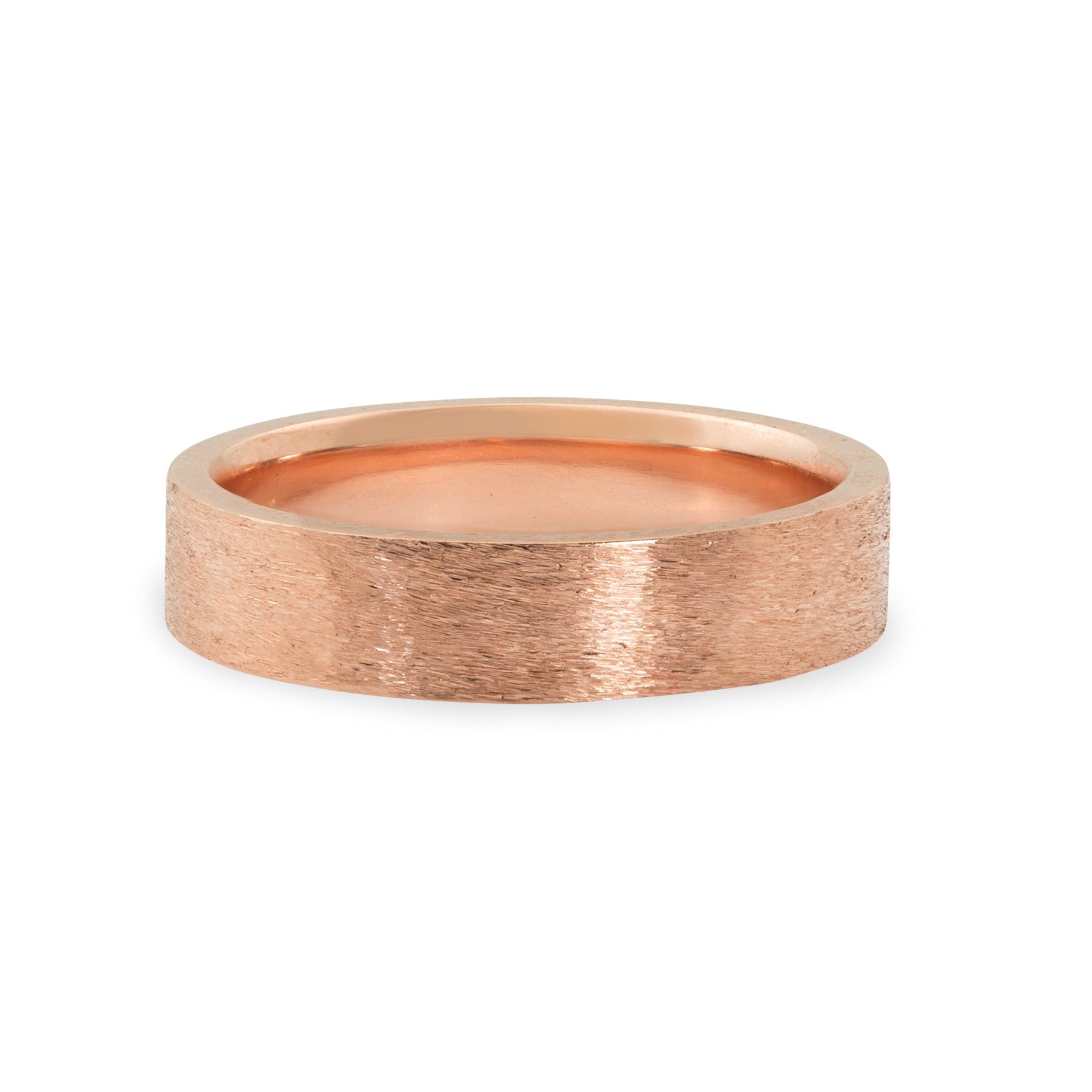 14k rose gold wide band ring with rugged brushed texture squared edges and comfort fit interior shown laying on side on white background