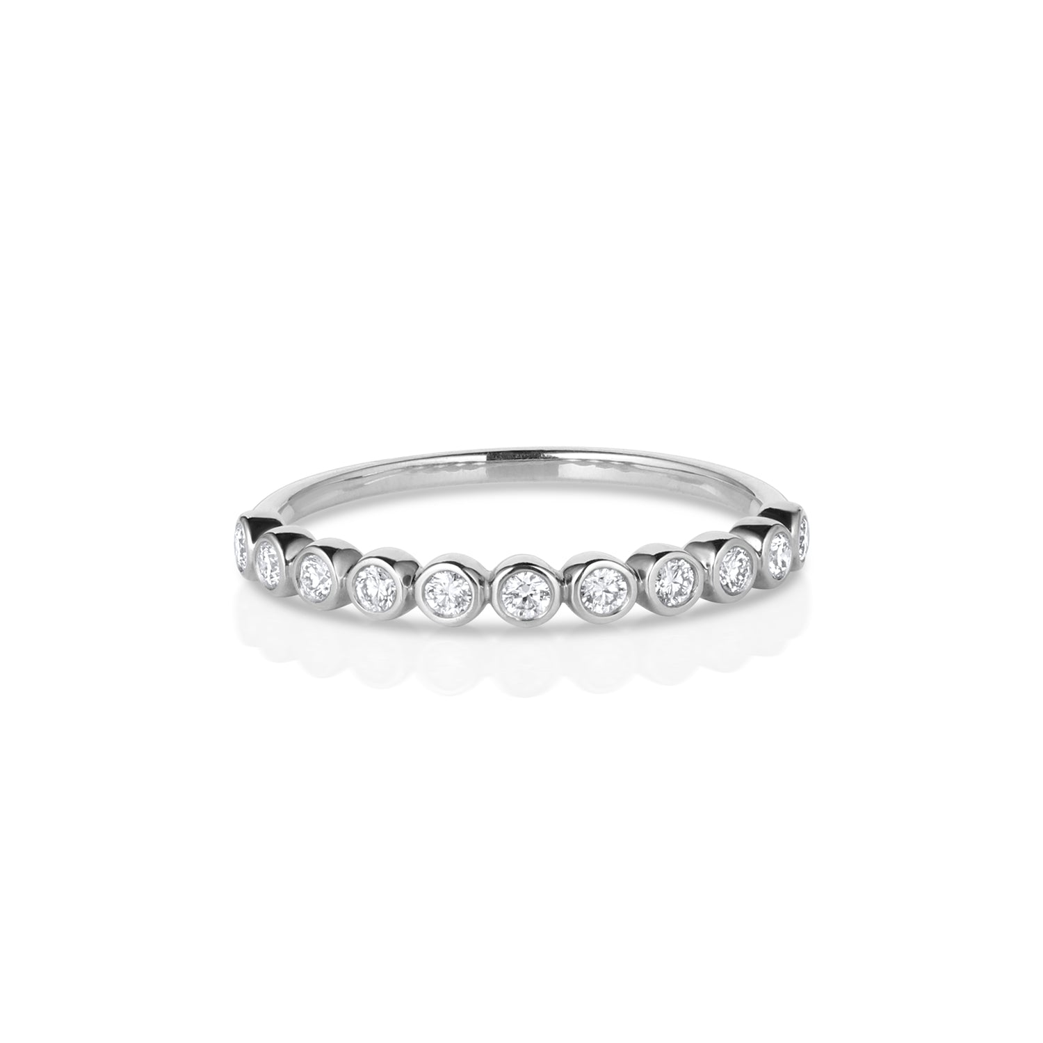 14k white gold ring with small round white bezel set diamonds in a half eternity setting on a white background