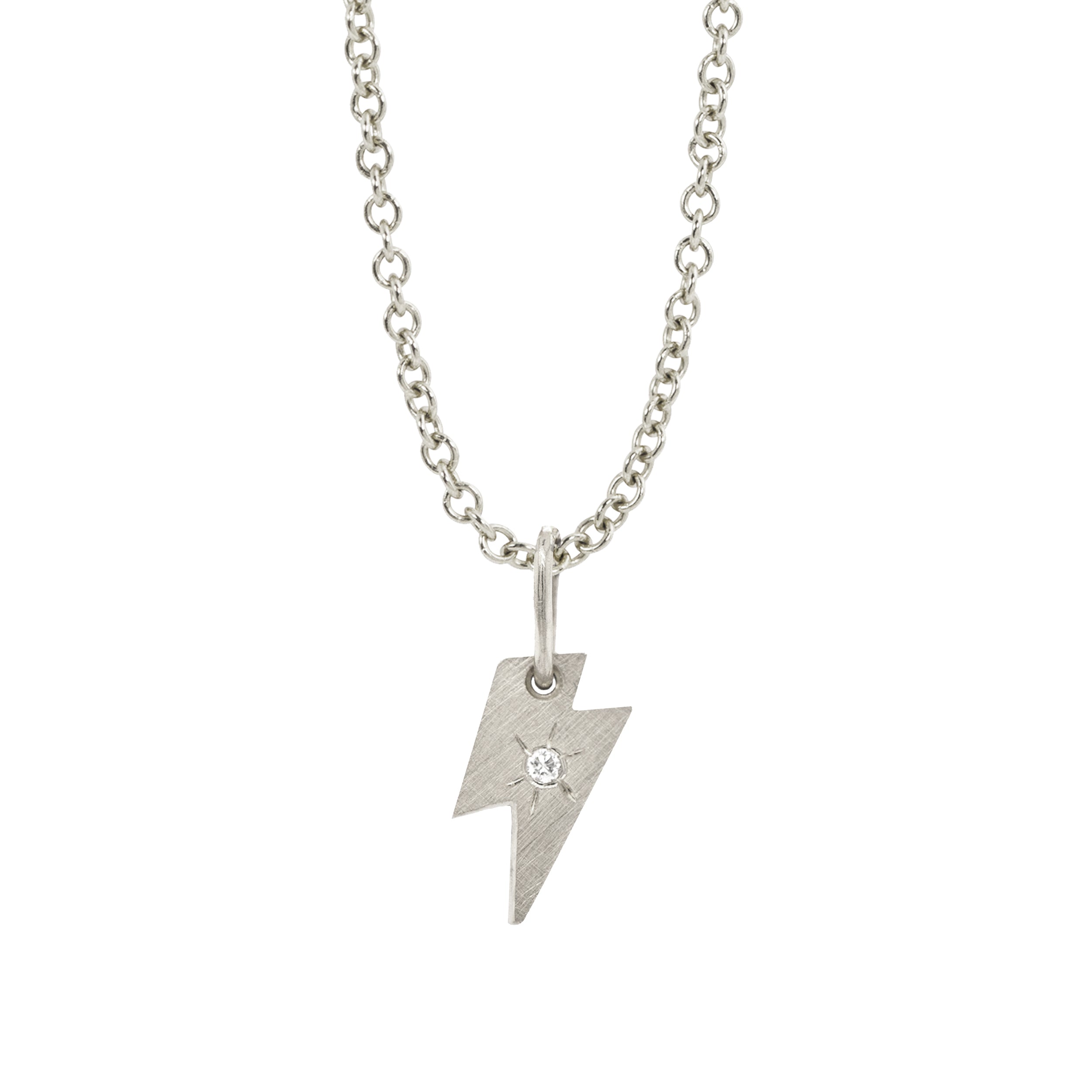 14k white gold lightning bolt pendant with white diamond and hand etched starburst on a white background