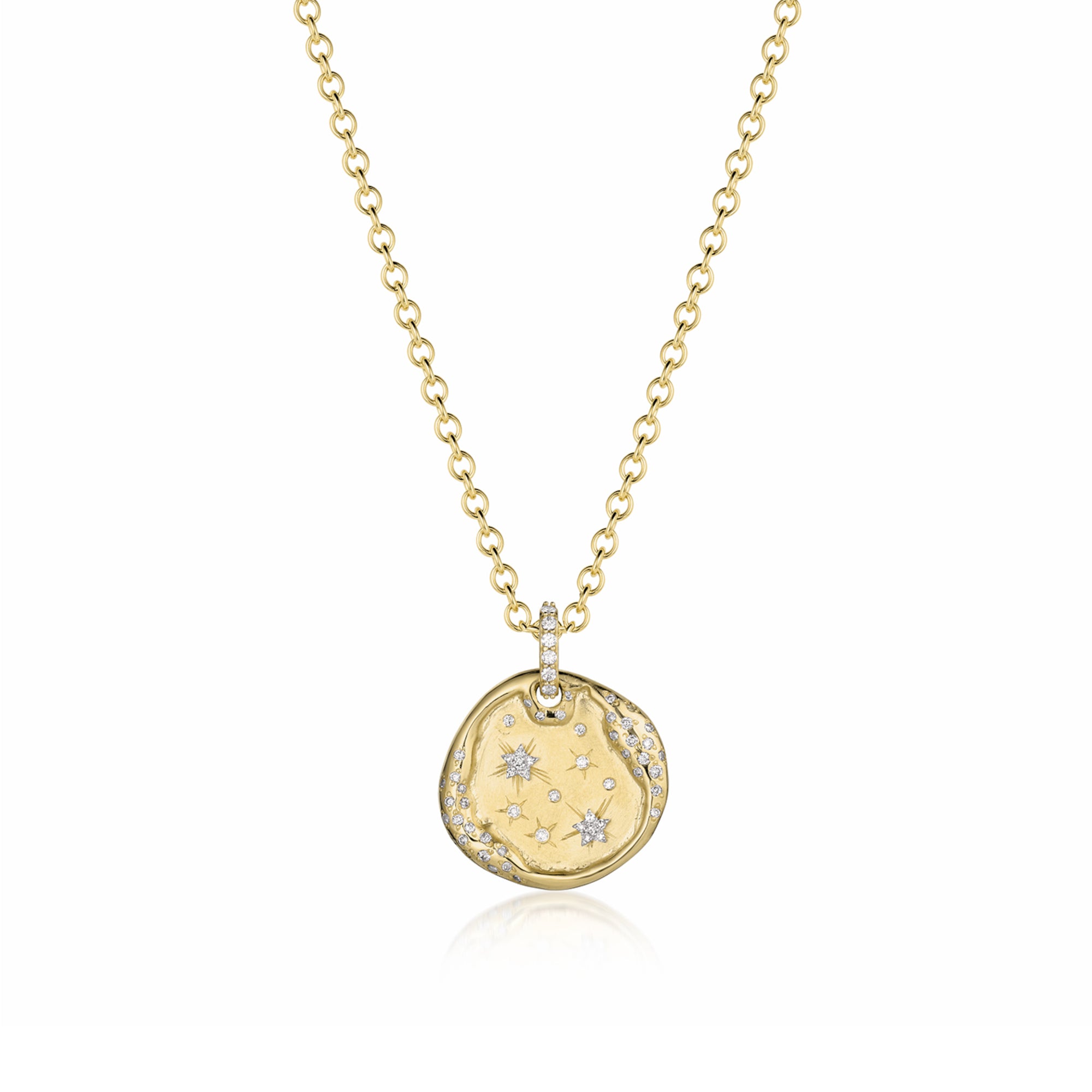 14k Gold pendant organic round shape dog tag scattered with white diamond accents, pave bale and hand engraved stars on shown with rolo chain. On a white background.