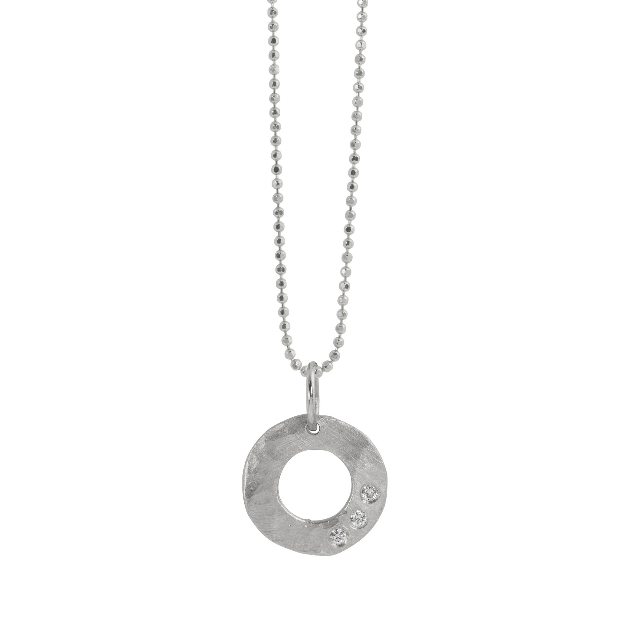 14k white gold open circle pendant with hammered finish and three white diamonds on a white background