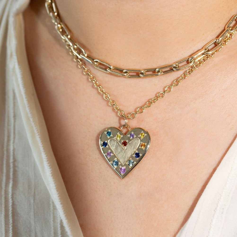 14k yellow gold large heart pendant of complimenting shiny and satin finish with outer edge of mixed color sapphires