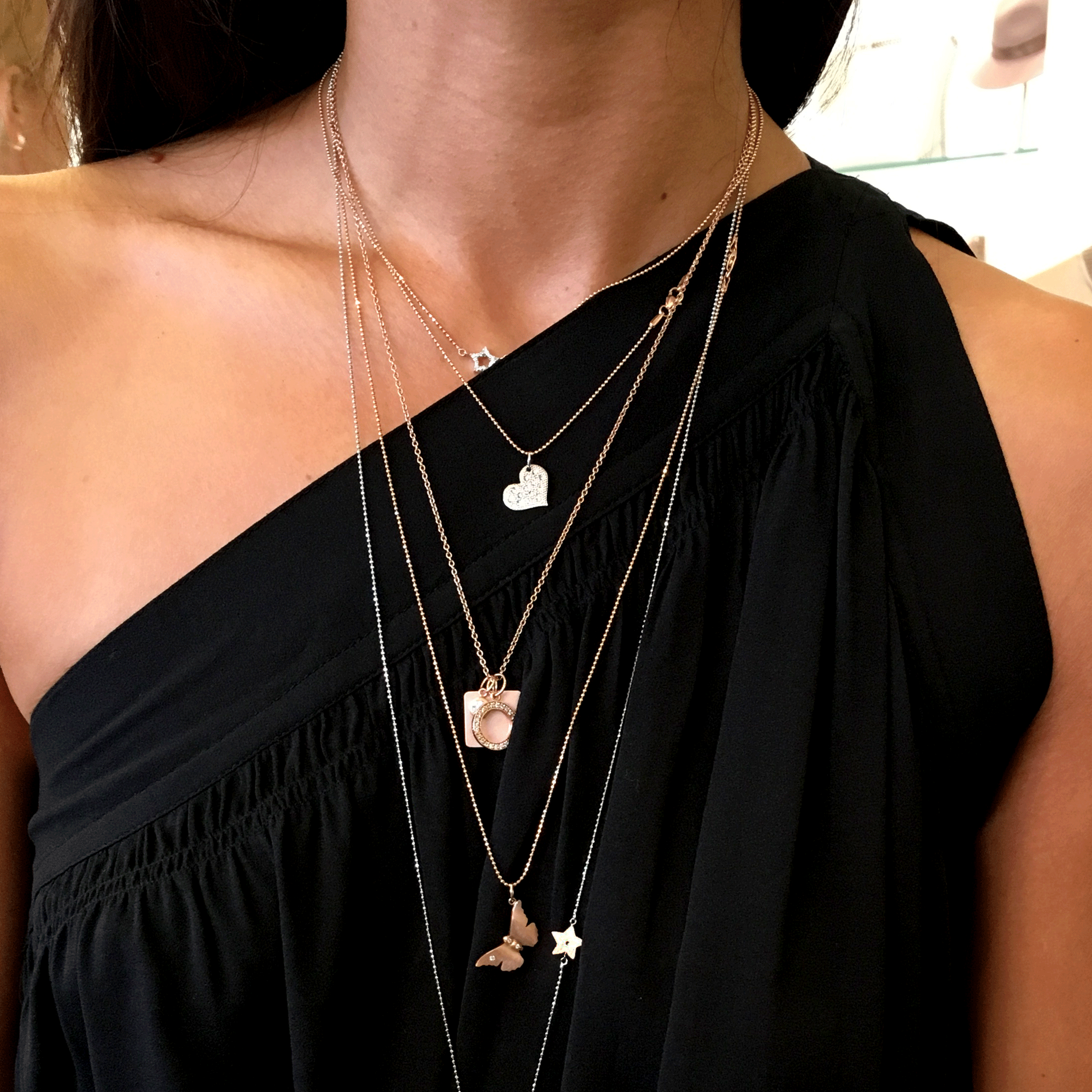 14k gold LAVA baby heart with scattered diamonds on model