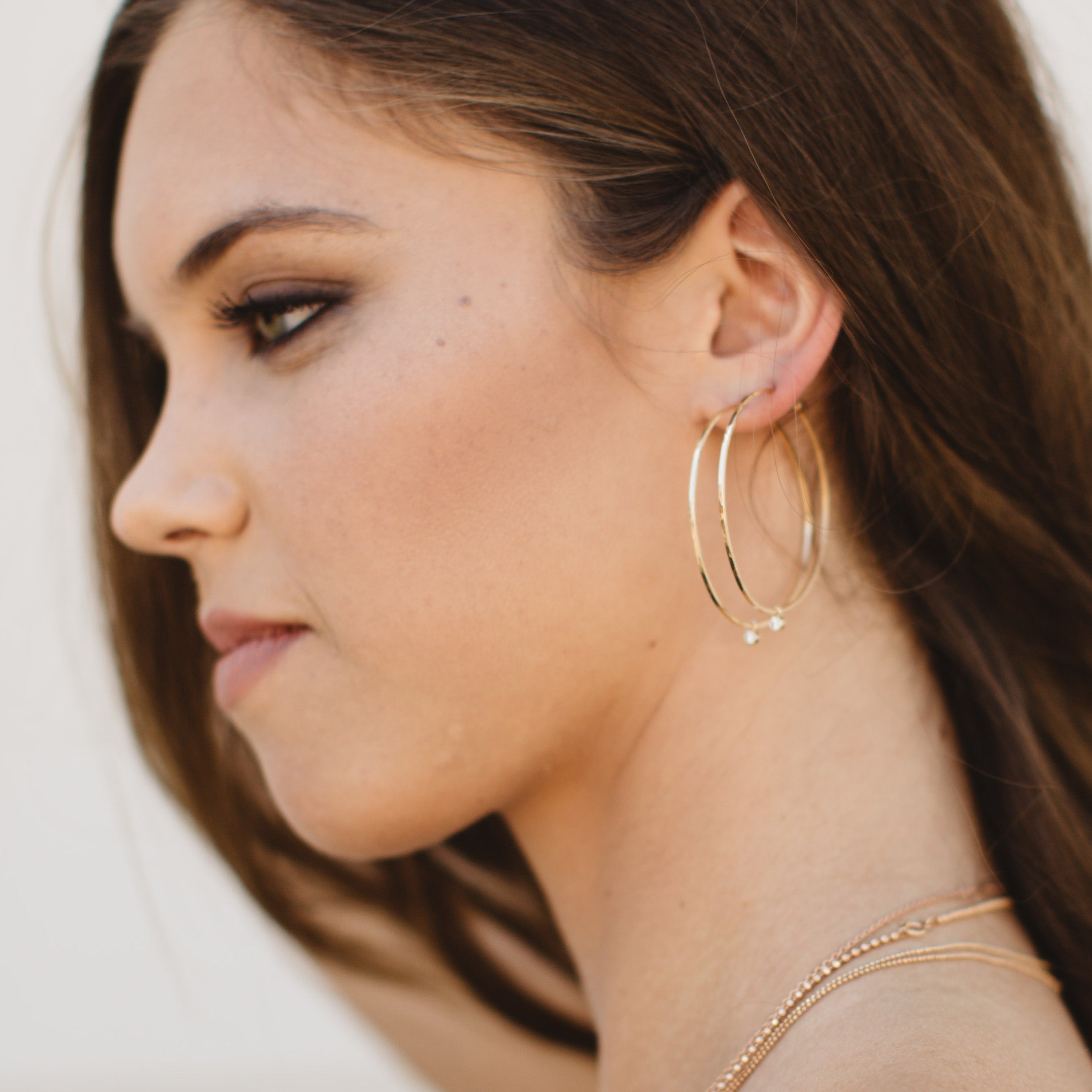 14k gold BEZI diamond hoop charms for ORMS hoops on model